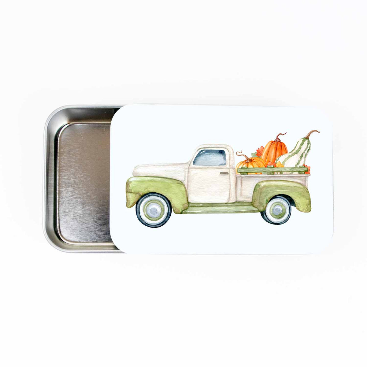 Pumpkin Truck stitch marker storage tin, slide-style tin open to show the empty metal tray, lid painted with a watercolor green truck loaded with pumpkins and gourds