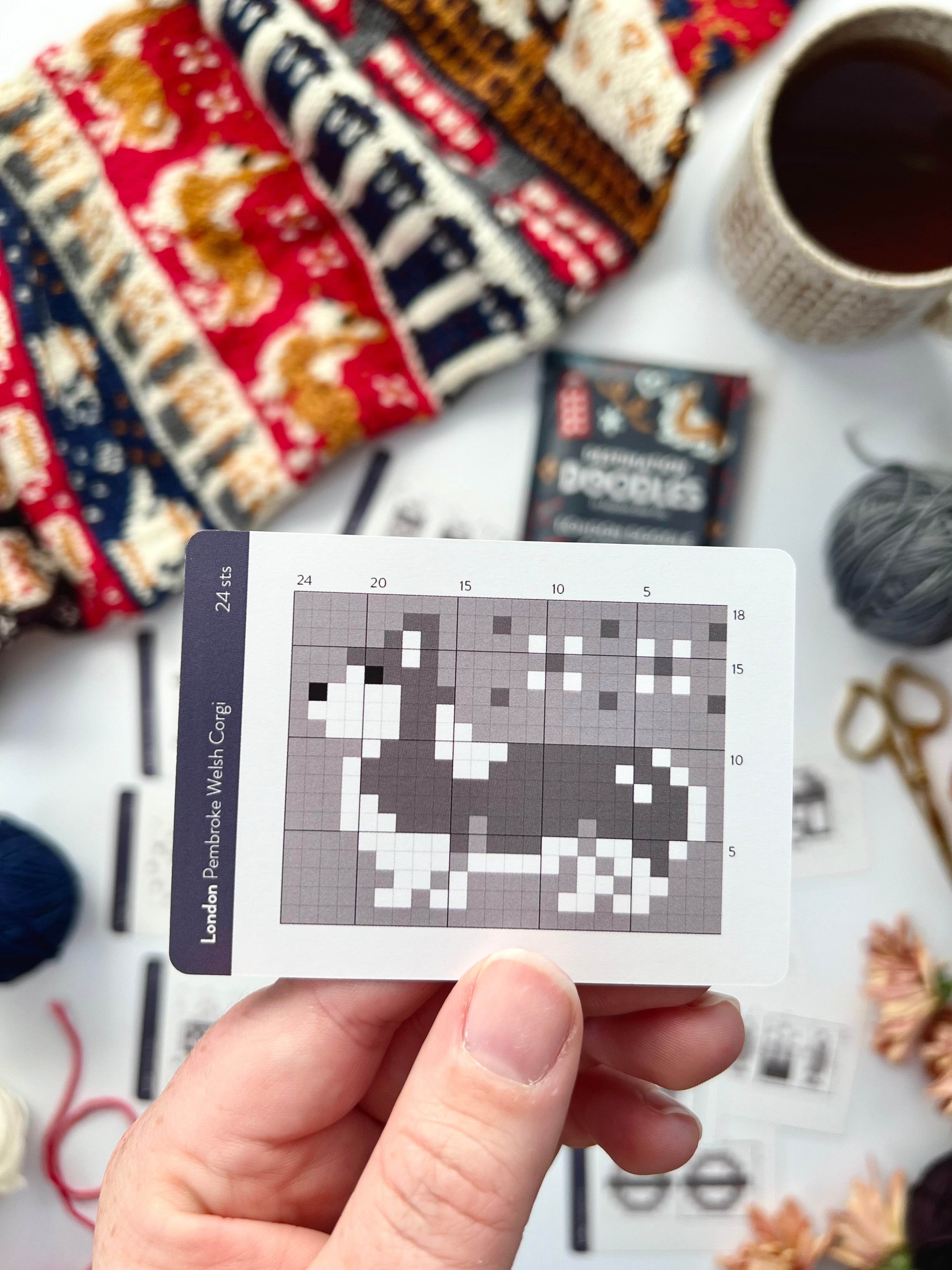 Hand holding a London Doodle Pembroke Welsh corgi colorwork chart card