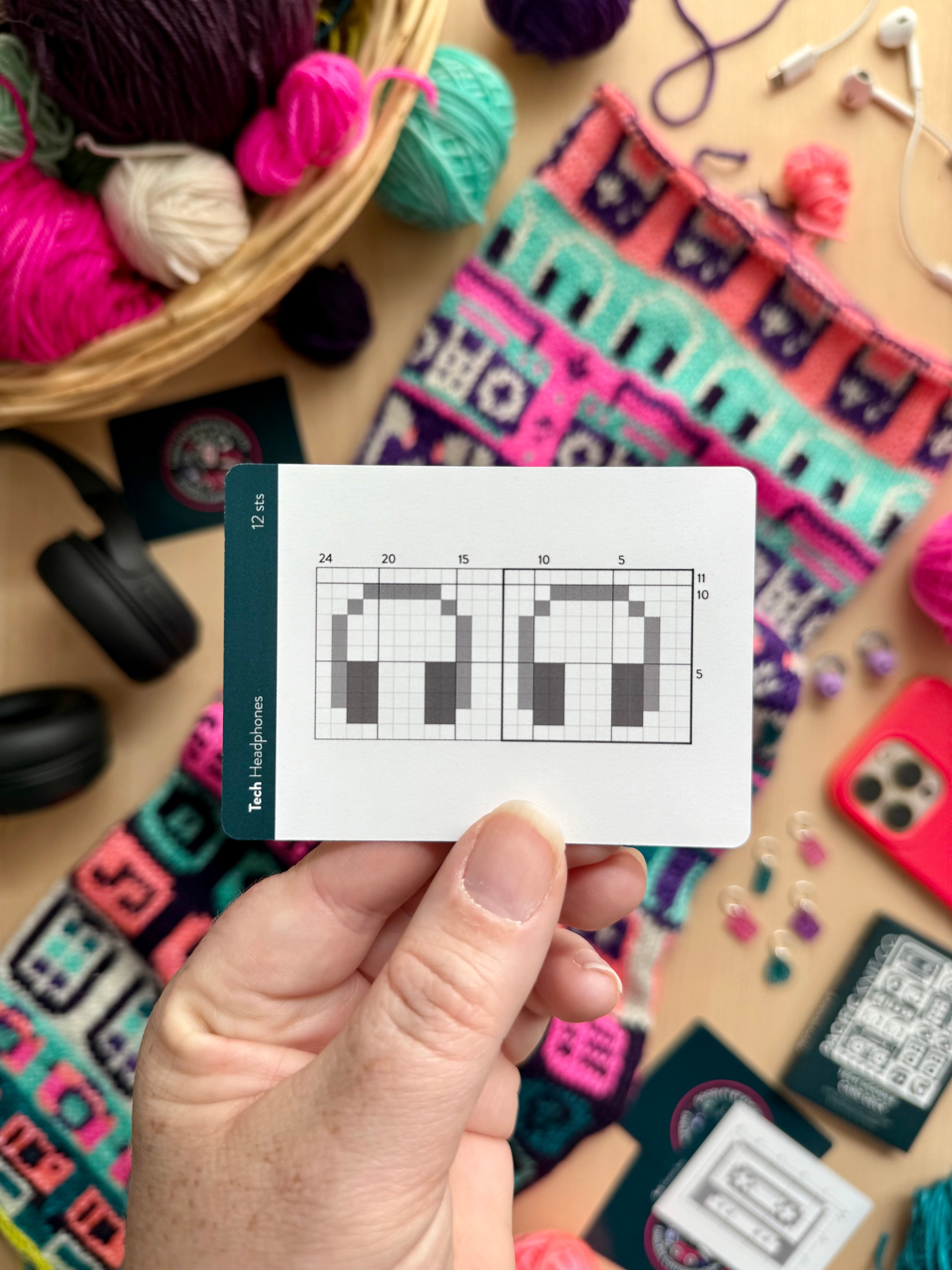 Hand holding a Tech Doodle headphones colorwork chart card