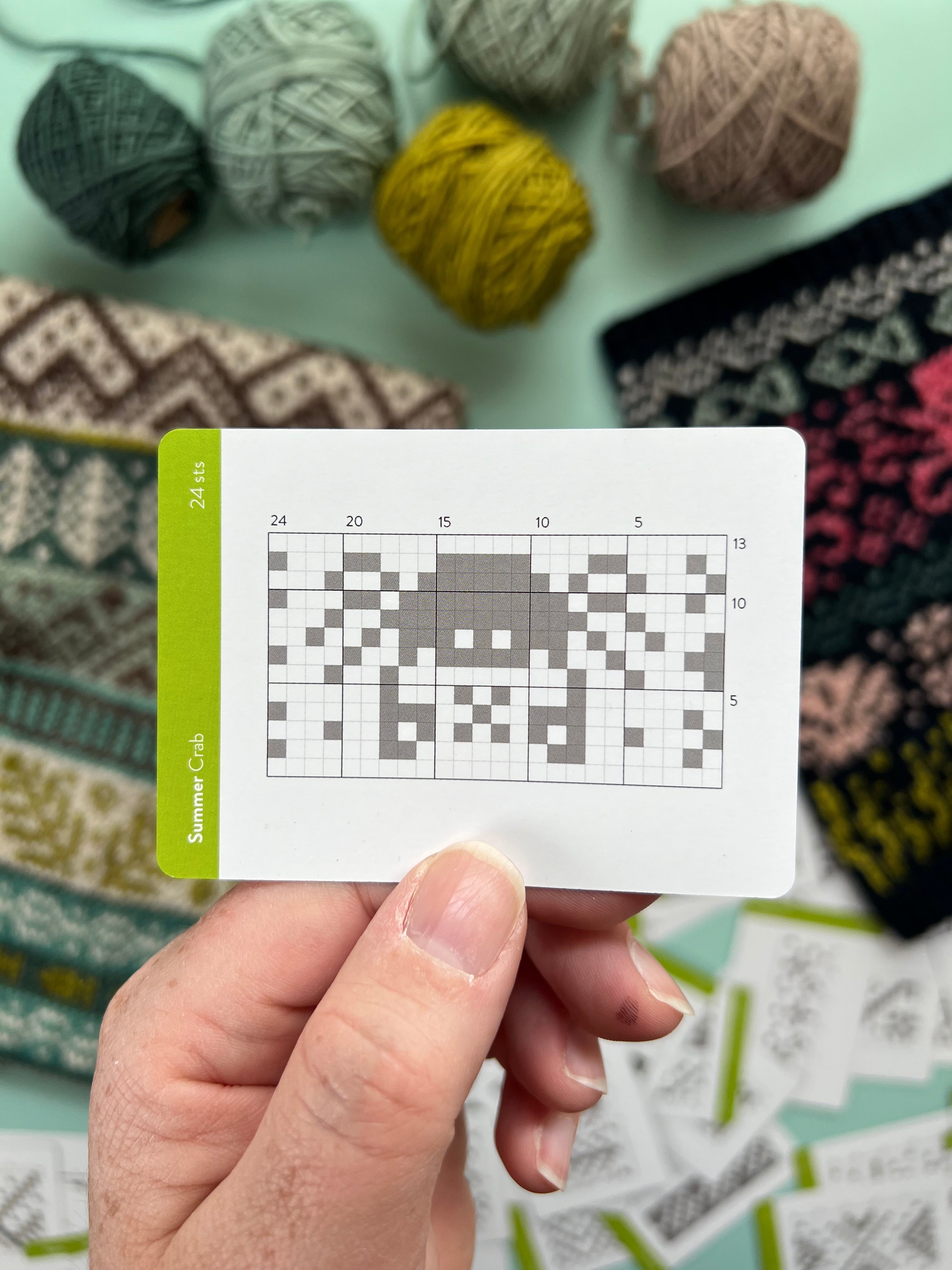 Hand holding a Summer Doodle crab colorwork chart card