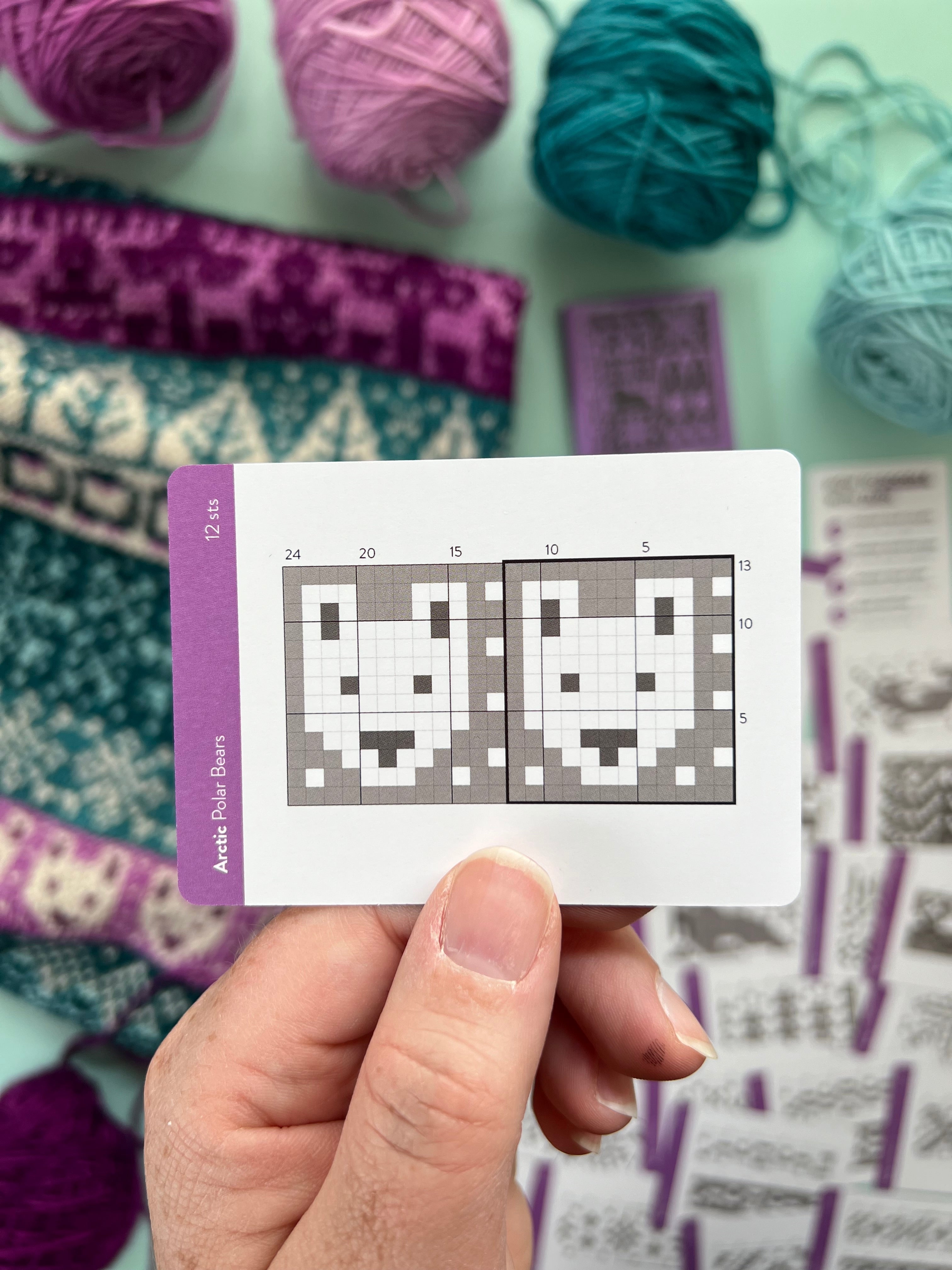 Hand holding an Arctic Doodle polar bear colorwork chart card