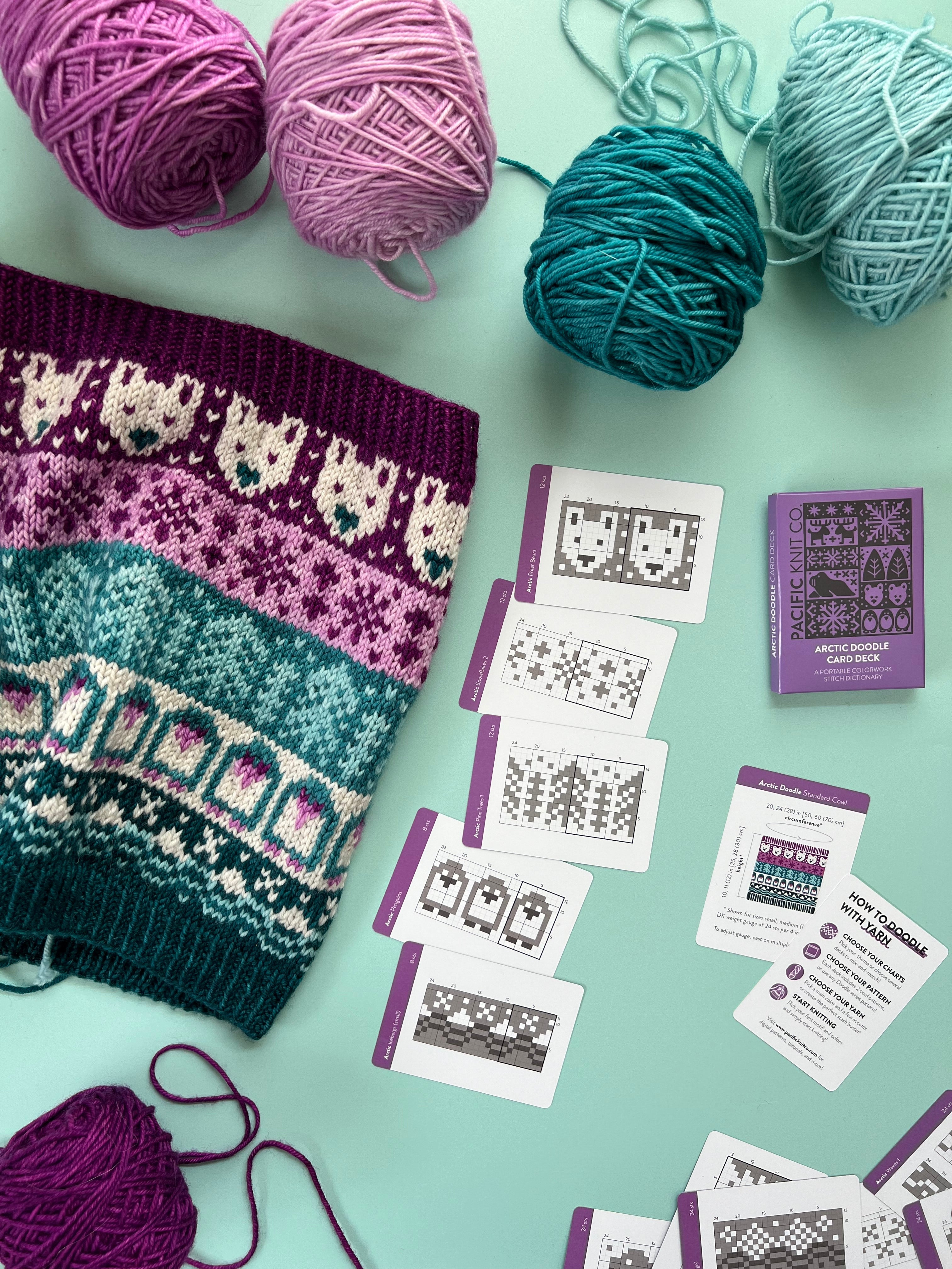 Arctic Doodle deck and chart cards beside a polar bear colorwork knit and yarn balls