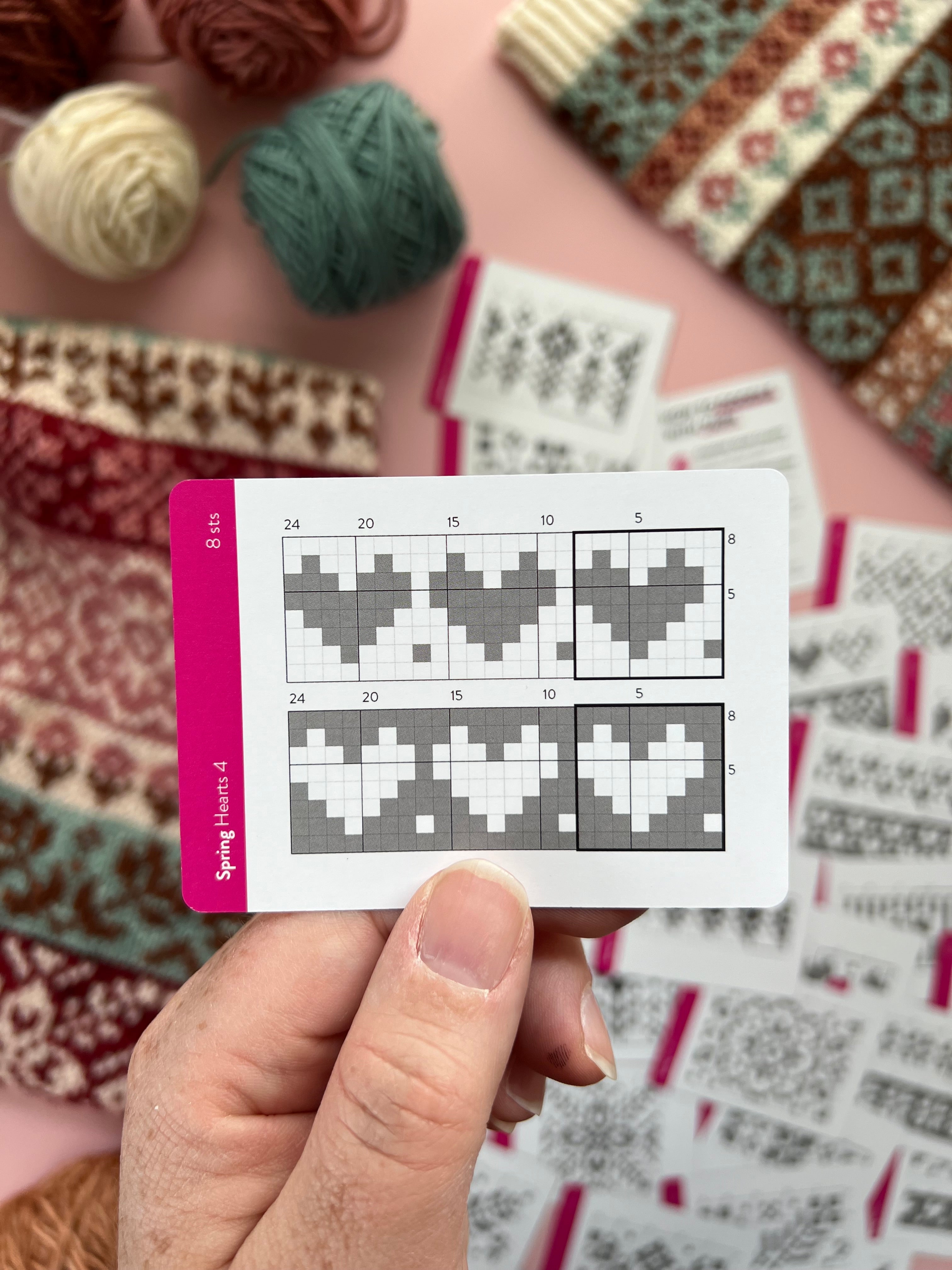 Hand holding a Spring Doodle hearts colorwork chart card