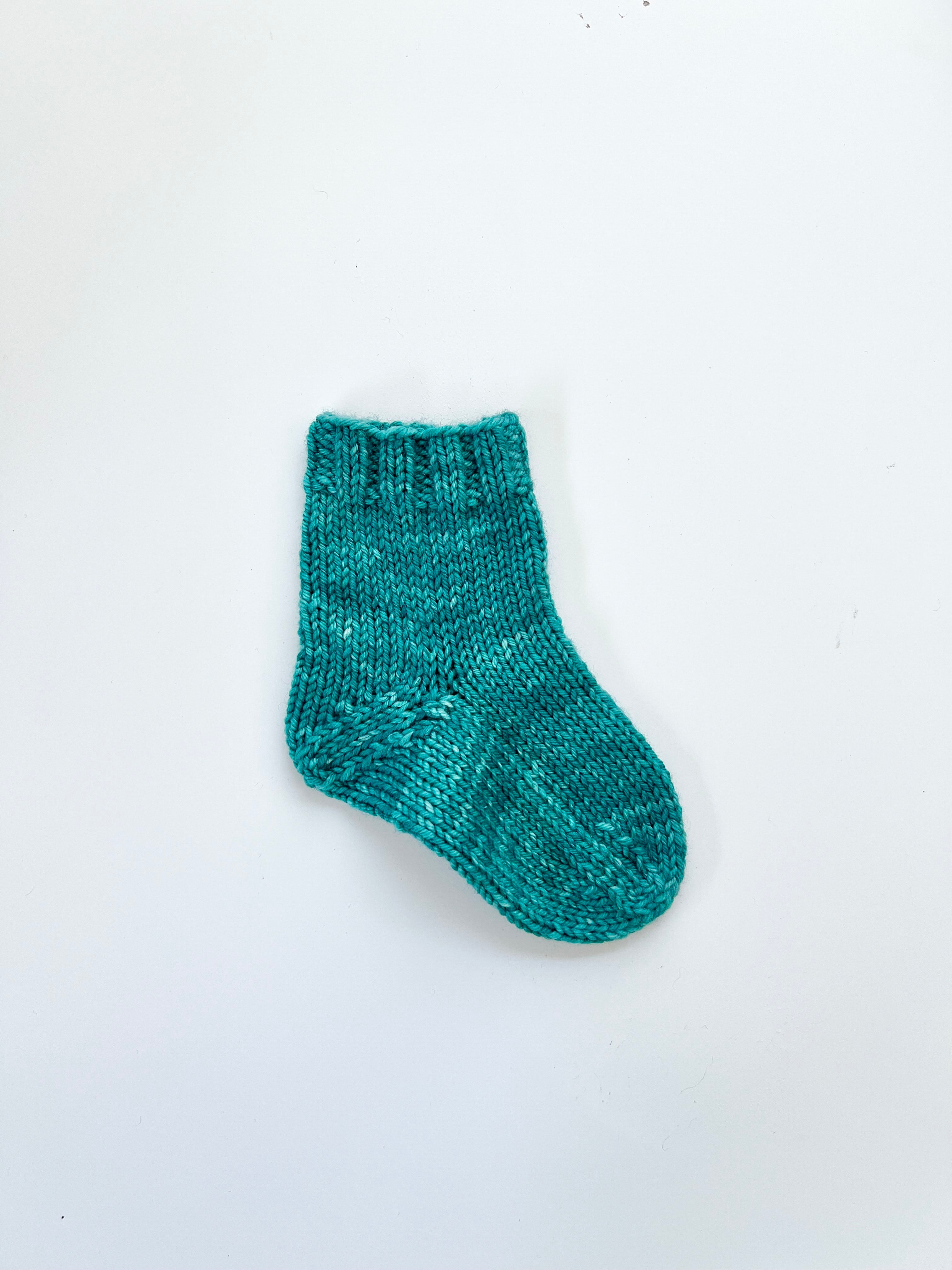 Small dark teal Base Doodle Top-Down Sock in DK weight yarn
