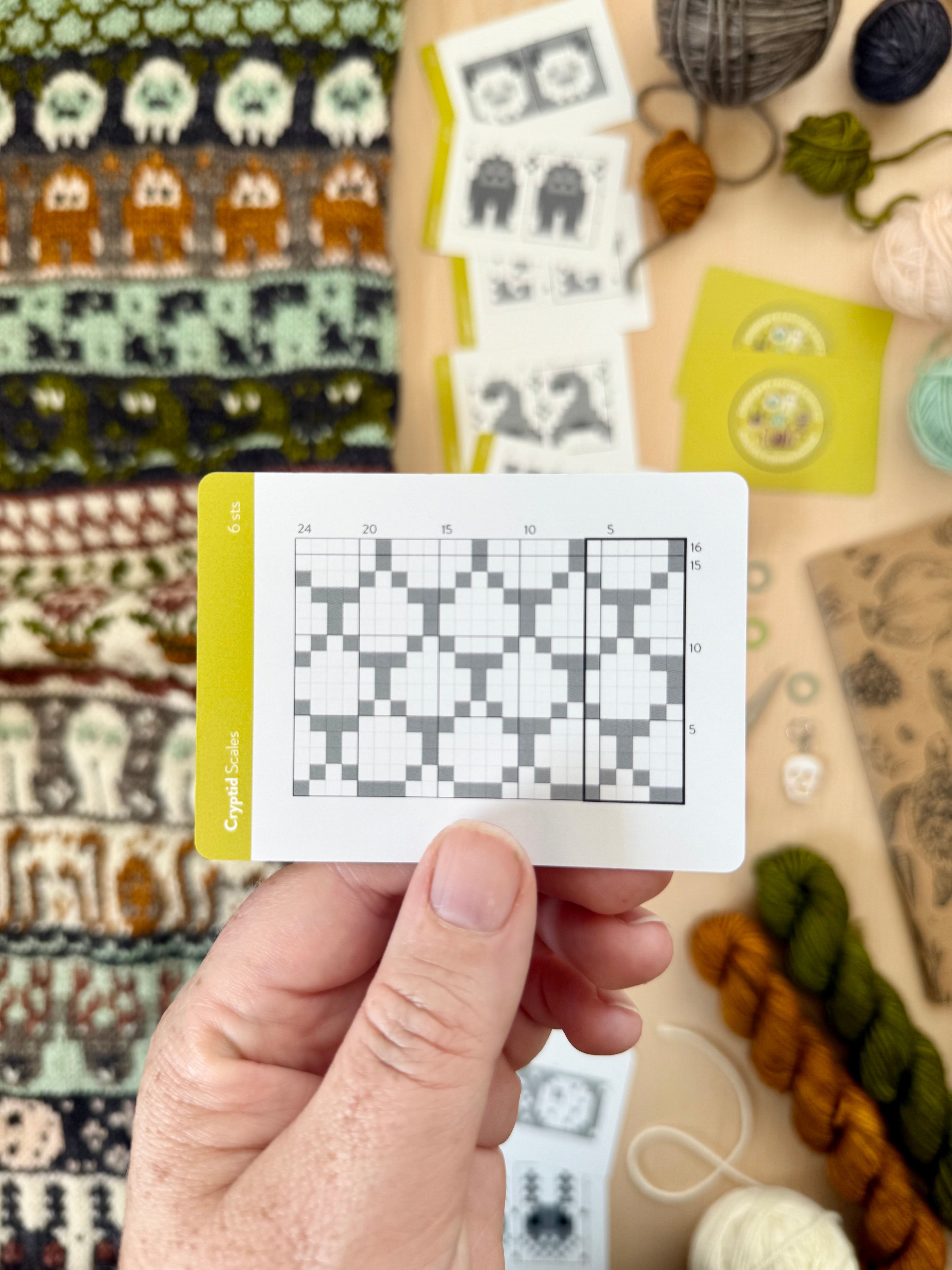Hand holding a Cryptid Doodle scales colorwork chart card
