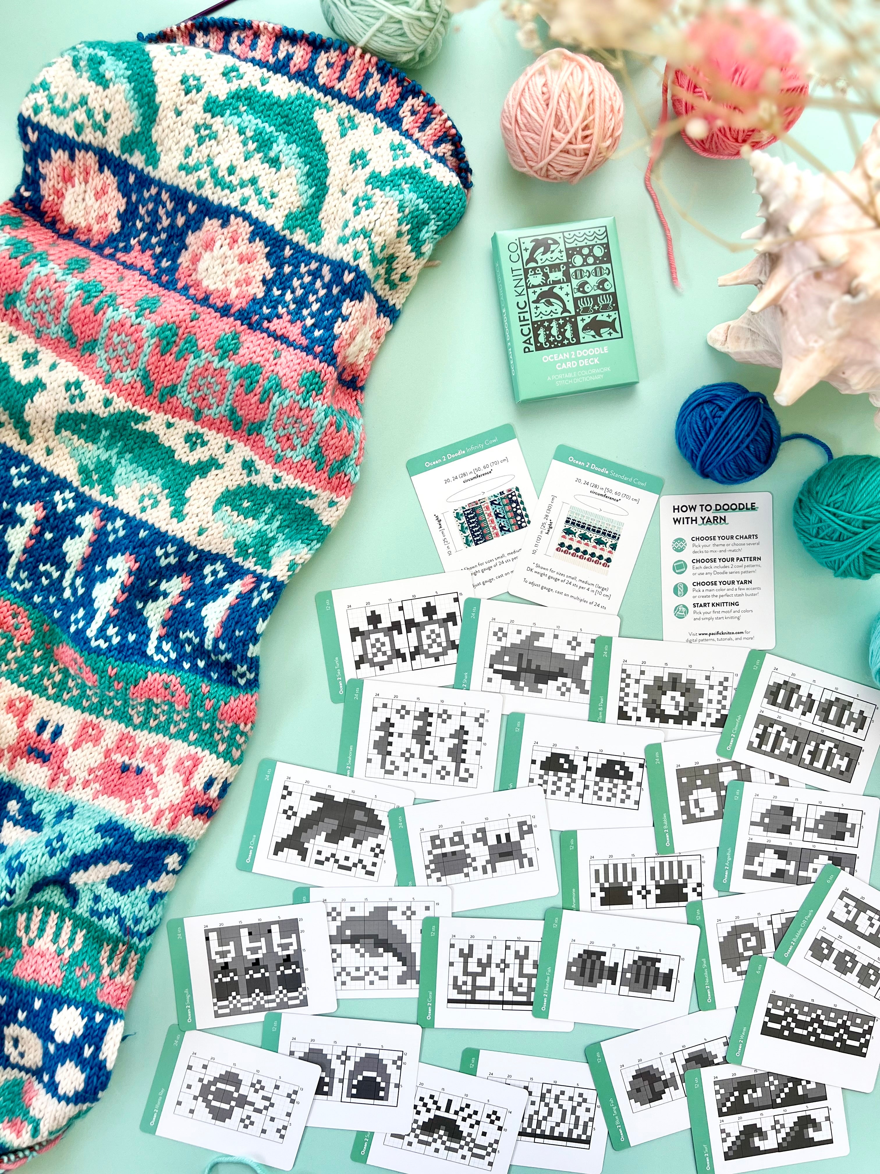 Ocean 2 Doodle chart cards beside a blue and coral sea life colorwork knit