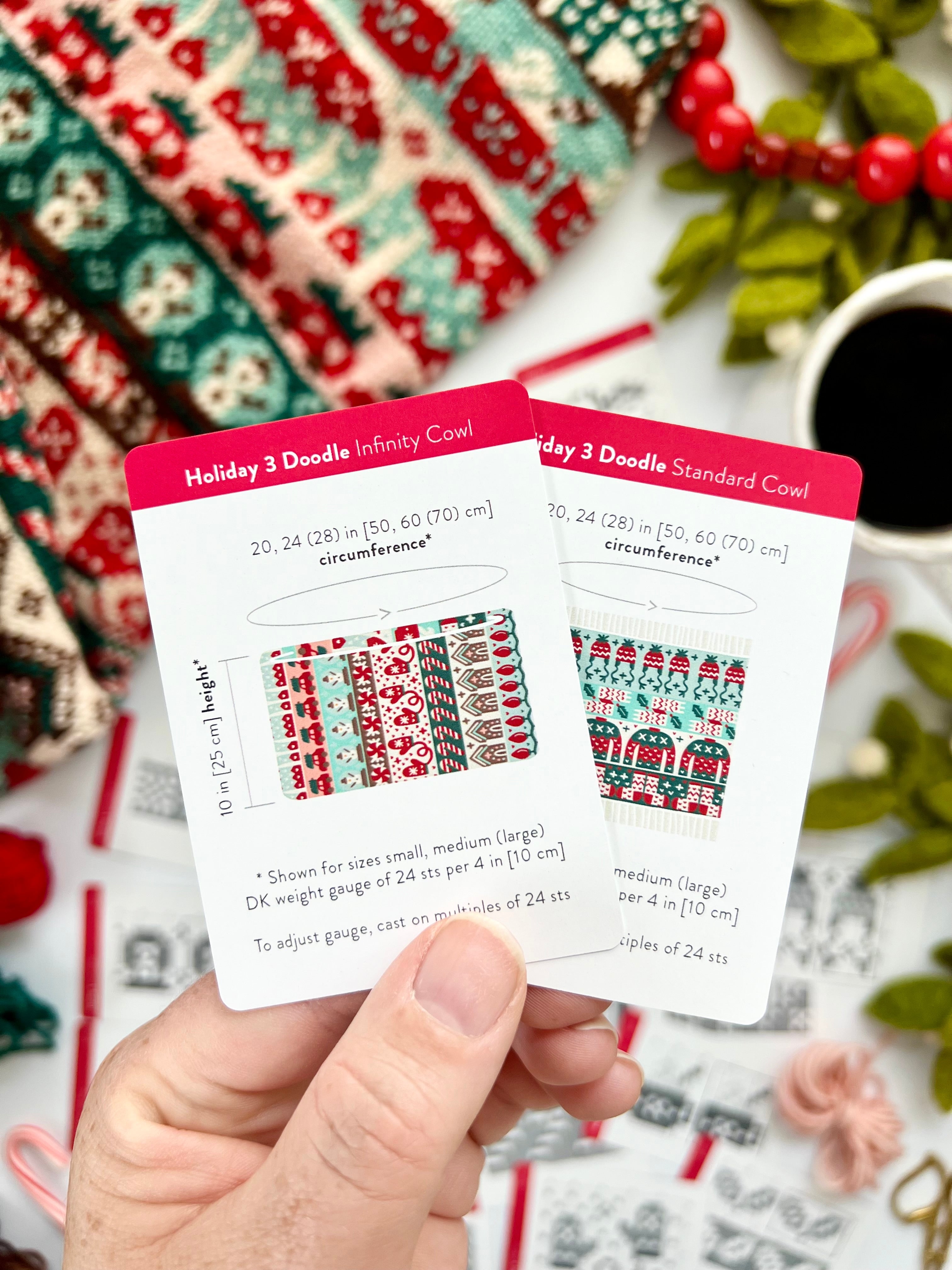 Hand holding the Holiday 3 Doodle Infinity Cowl and Standard Cowl schematic cards