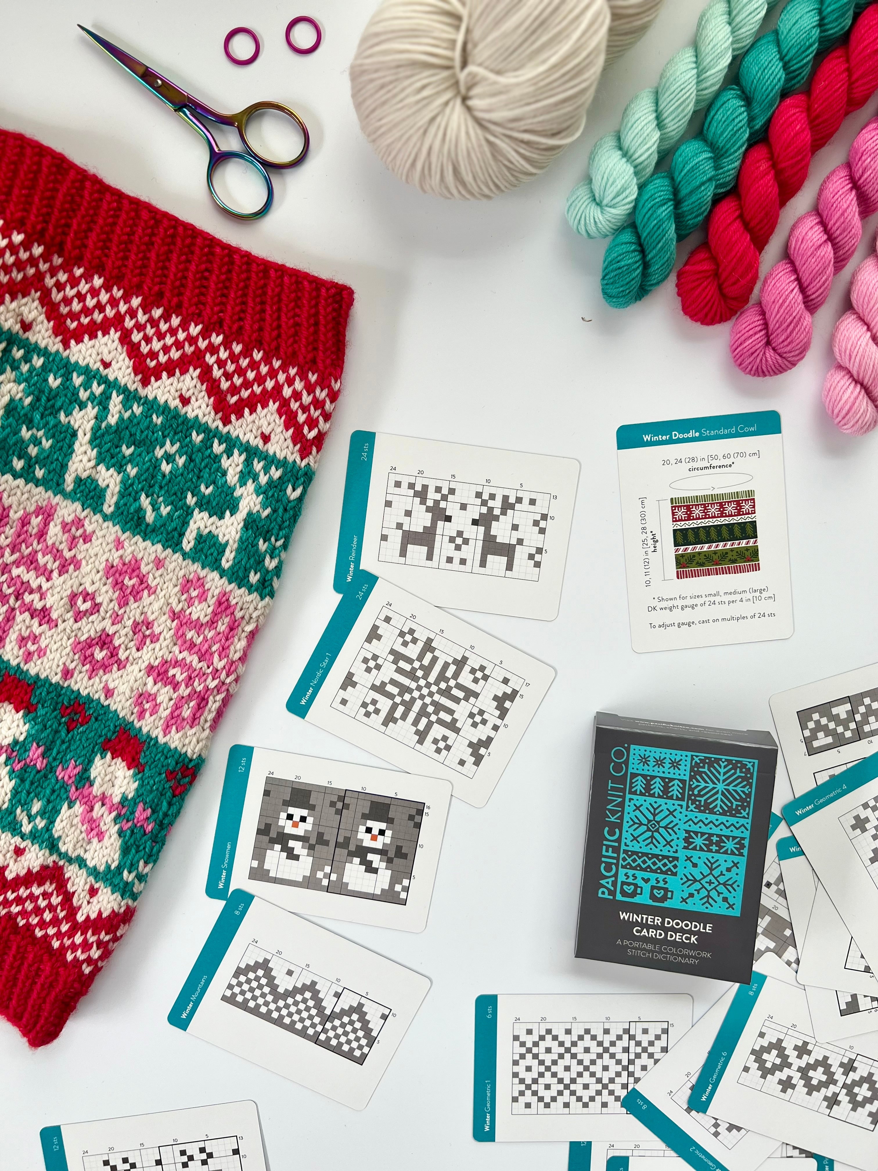 Winter Doodle deck and chart cards laid out with a festive colorwork knit and teal needles