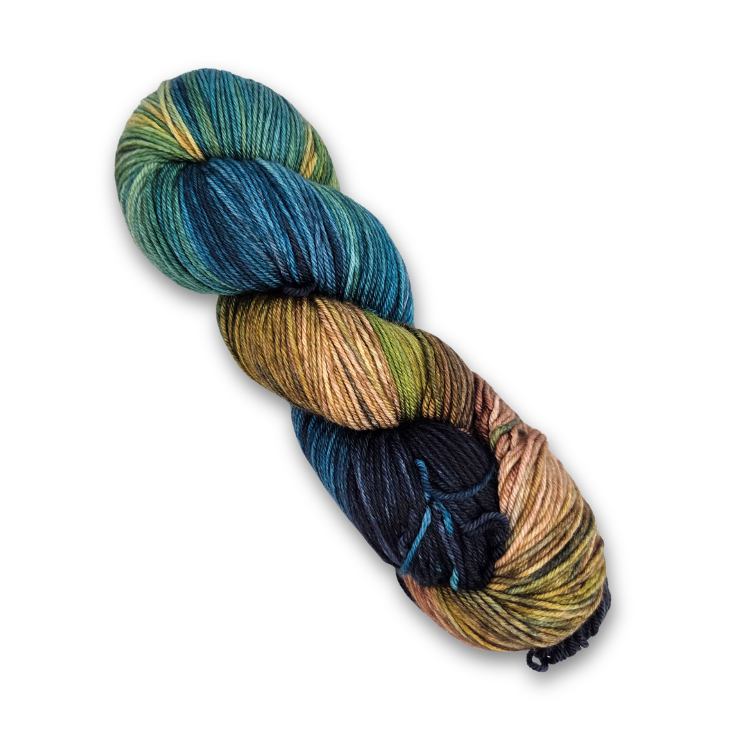 Yarnaceous Fibers Smuggler's Bay fingering weight sock yarn, 100g skein in deep teal, navy, gold and tan
