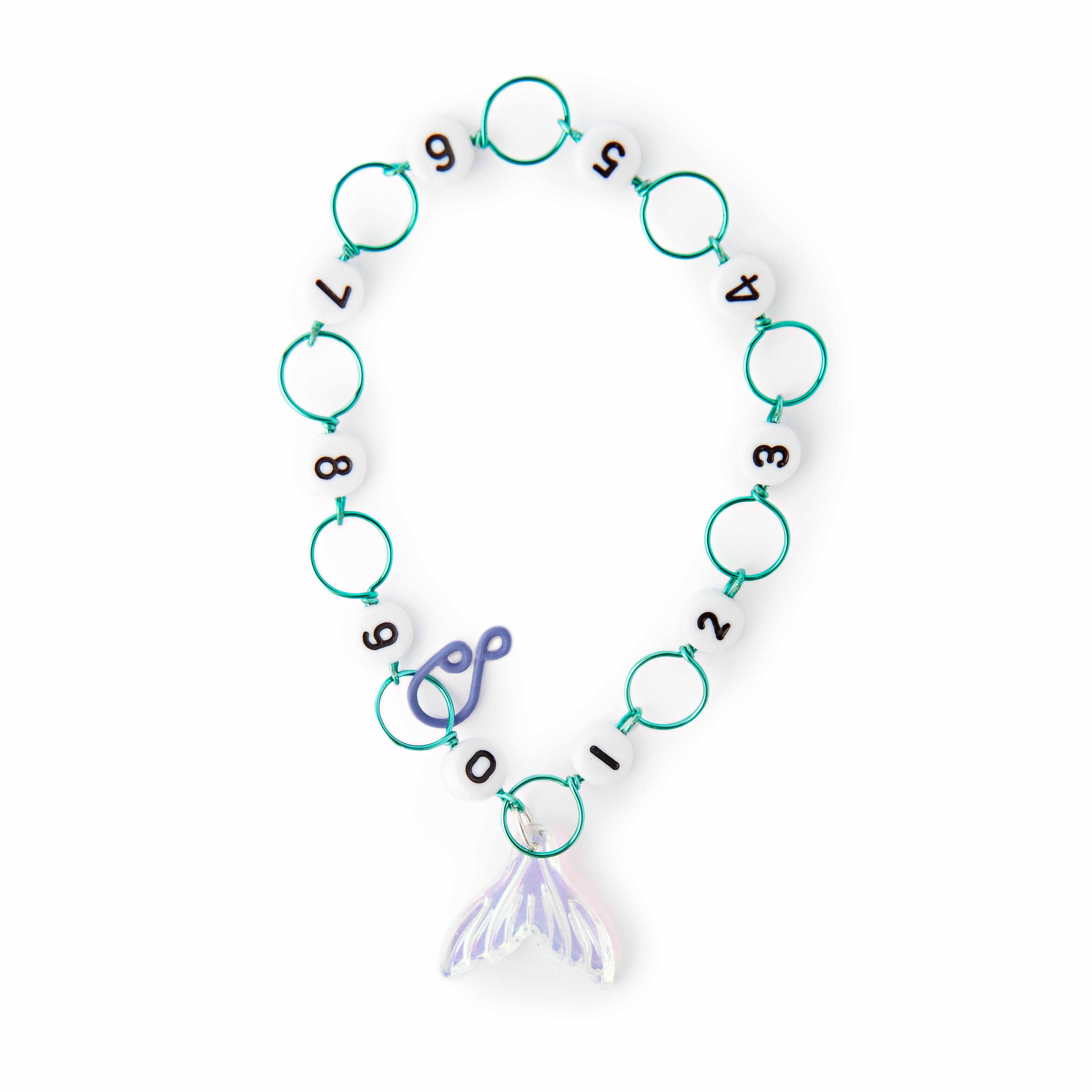 Mermaid Tail Row Counter from the 2026 Mermaid Summer Box with numbered beads 0 through 9 connected by teal rings and an iridescent lavender mermaid tail charm