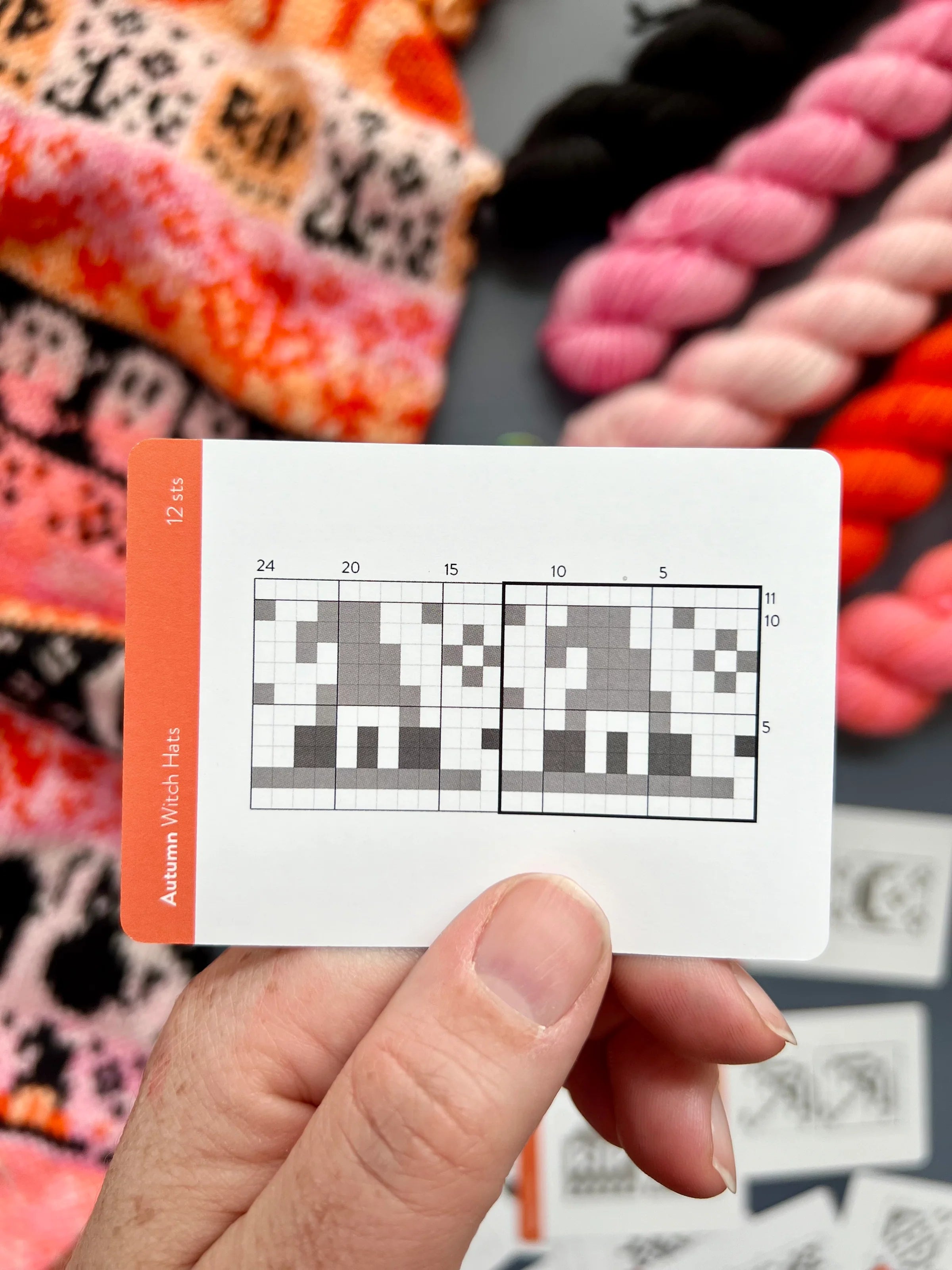 Hand holding an Autumn Doodle witch hat colorwork chart card