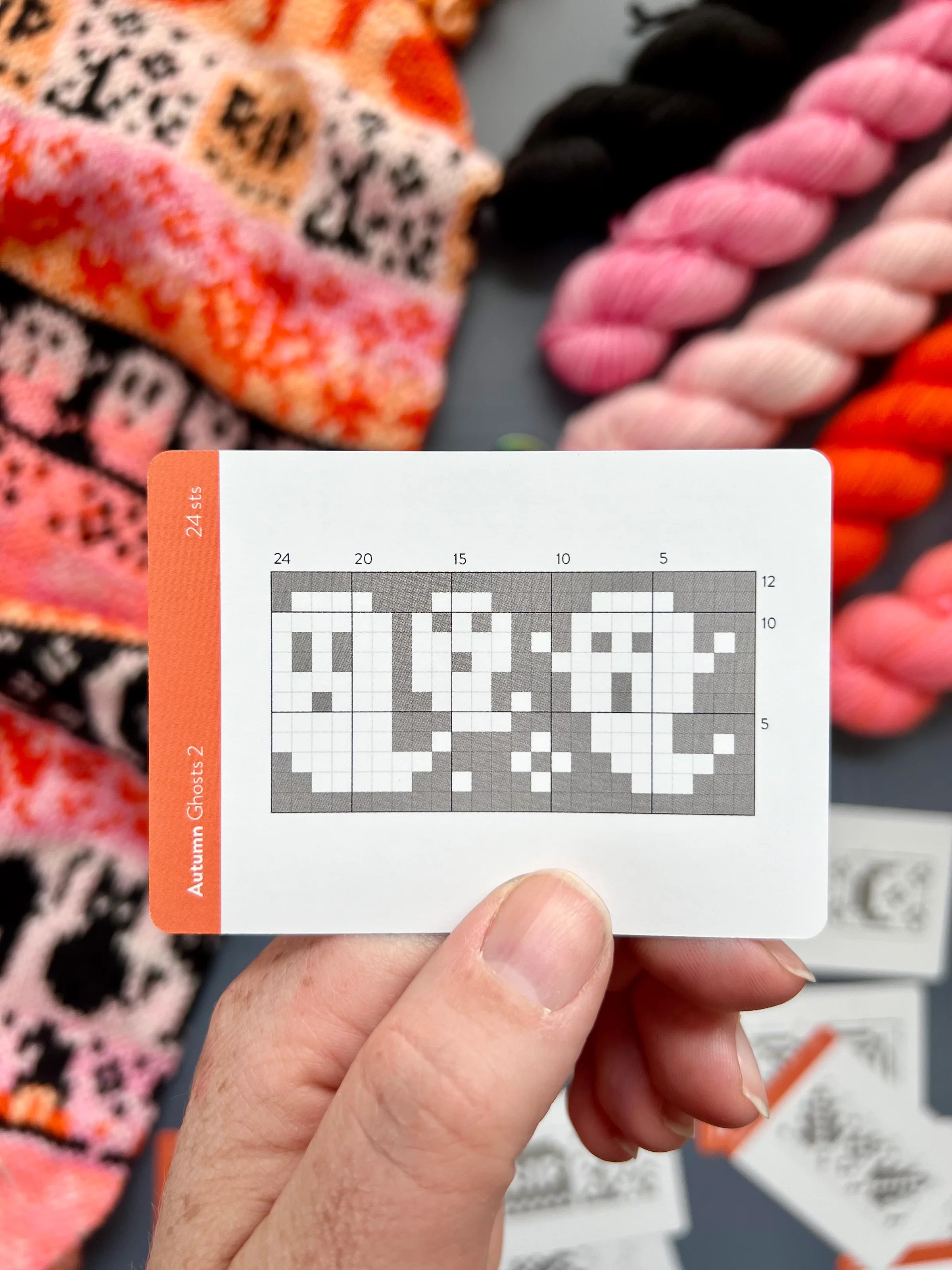 Hand holding an Autumn Doodle ghost colorwork chart card