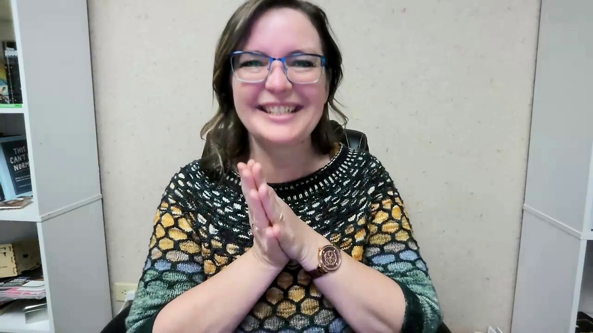 Dawn Prickett smiling while welcoming students to the Color Theory Made Easy class, wearing a colorwork sweater