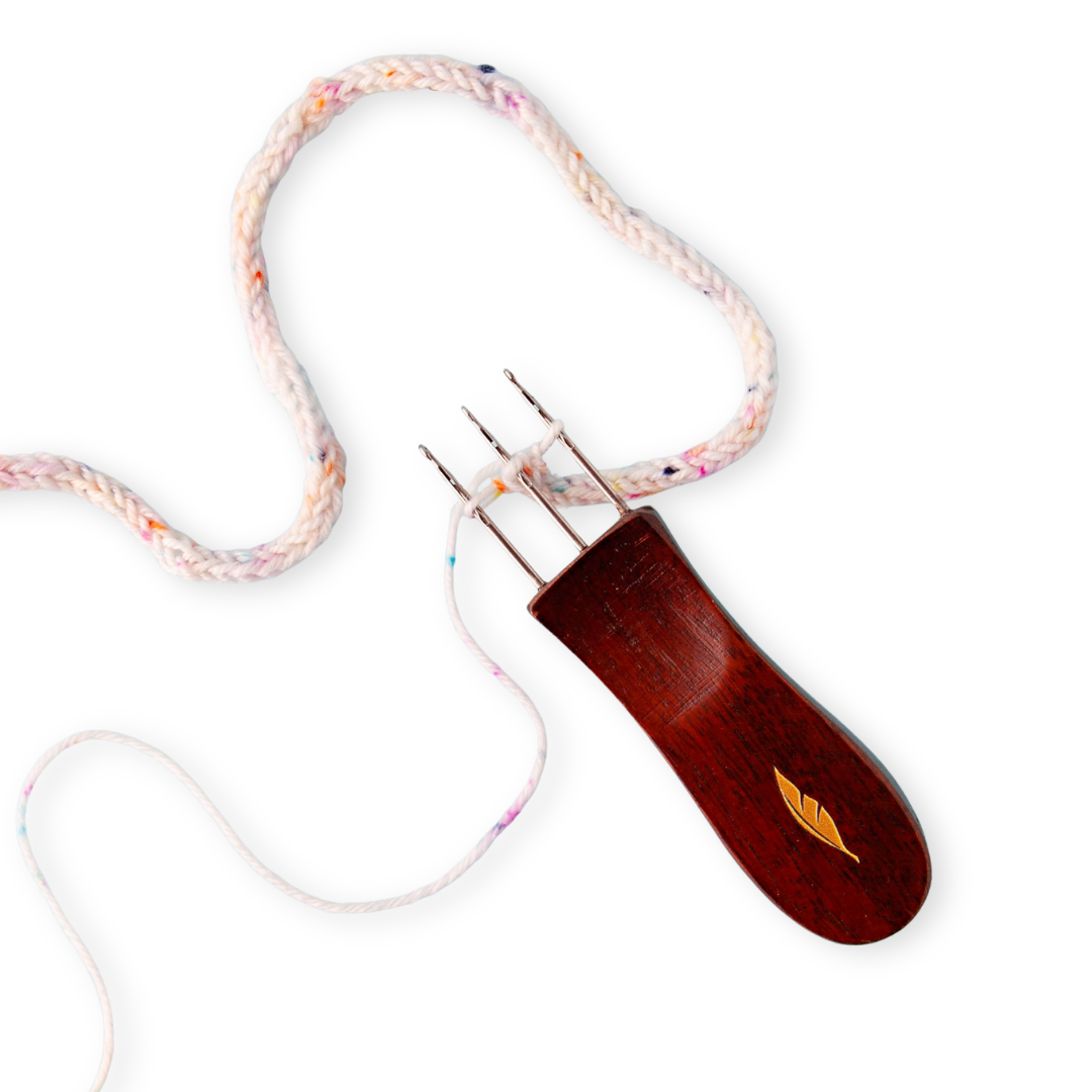 Cord Quill tool with dark wood handle and gold leaf inlay shown with a knitted i-cord from the 2026 Mermaid Summer Box