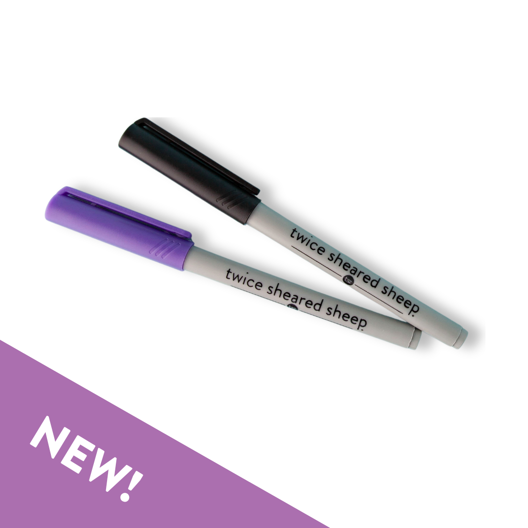 Set of two Twice Sheared Sheep branded wet erase markers with purple and black caps