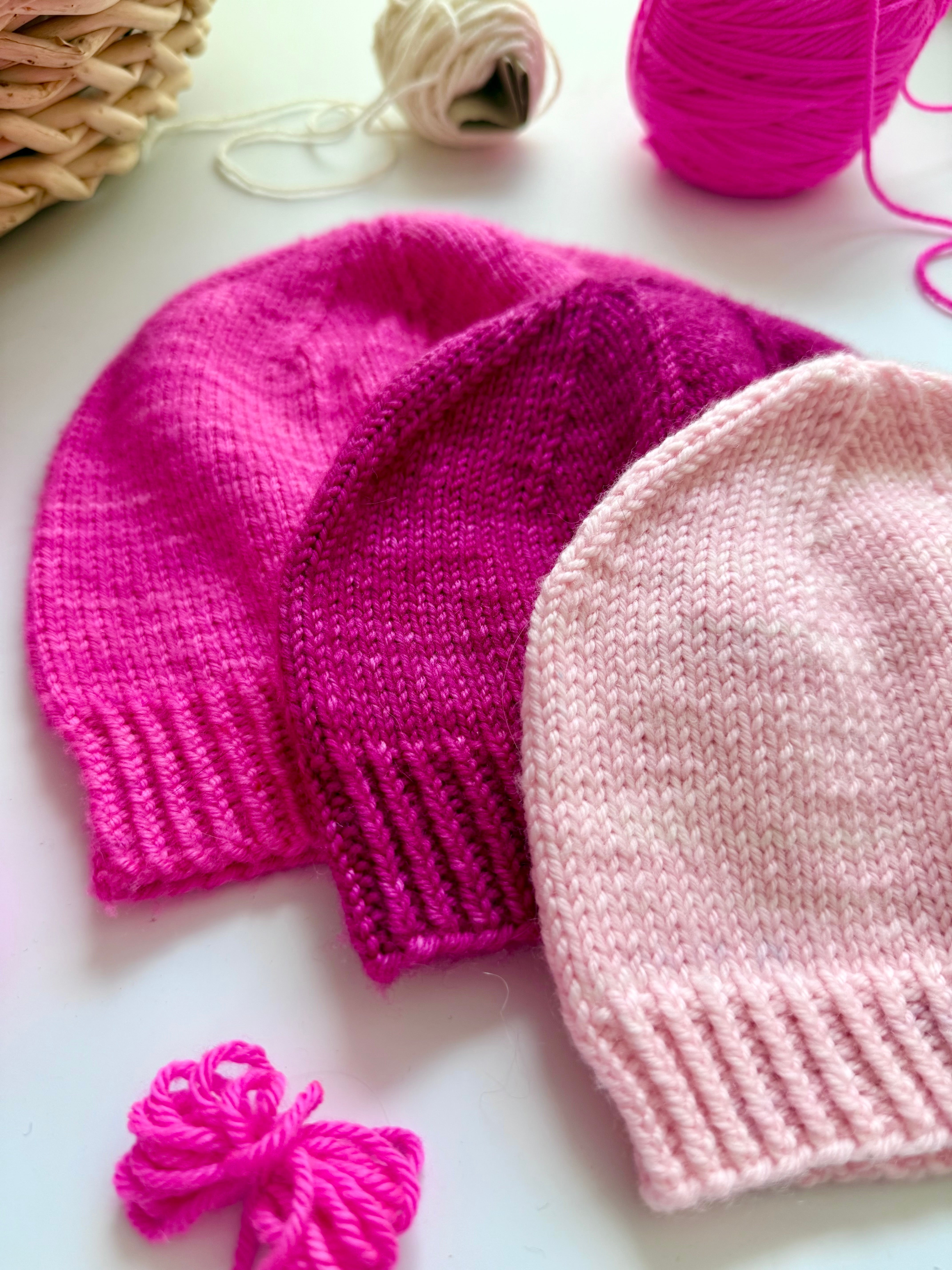 Close-up of three Base Doodle Beanie 1 hats showing the ribbed brims