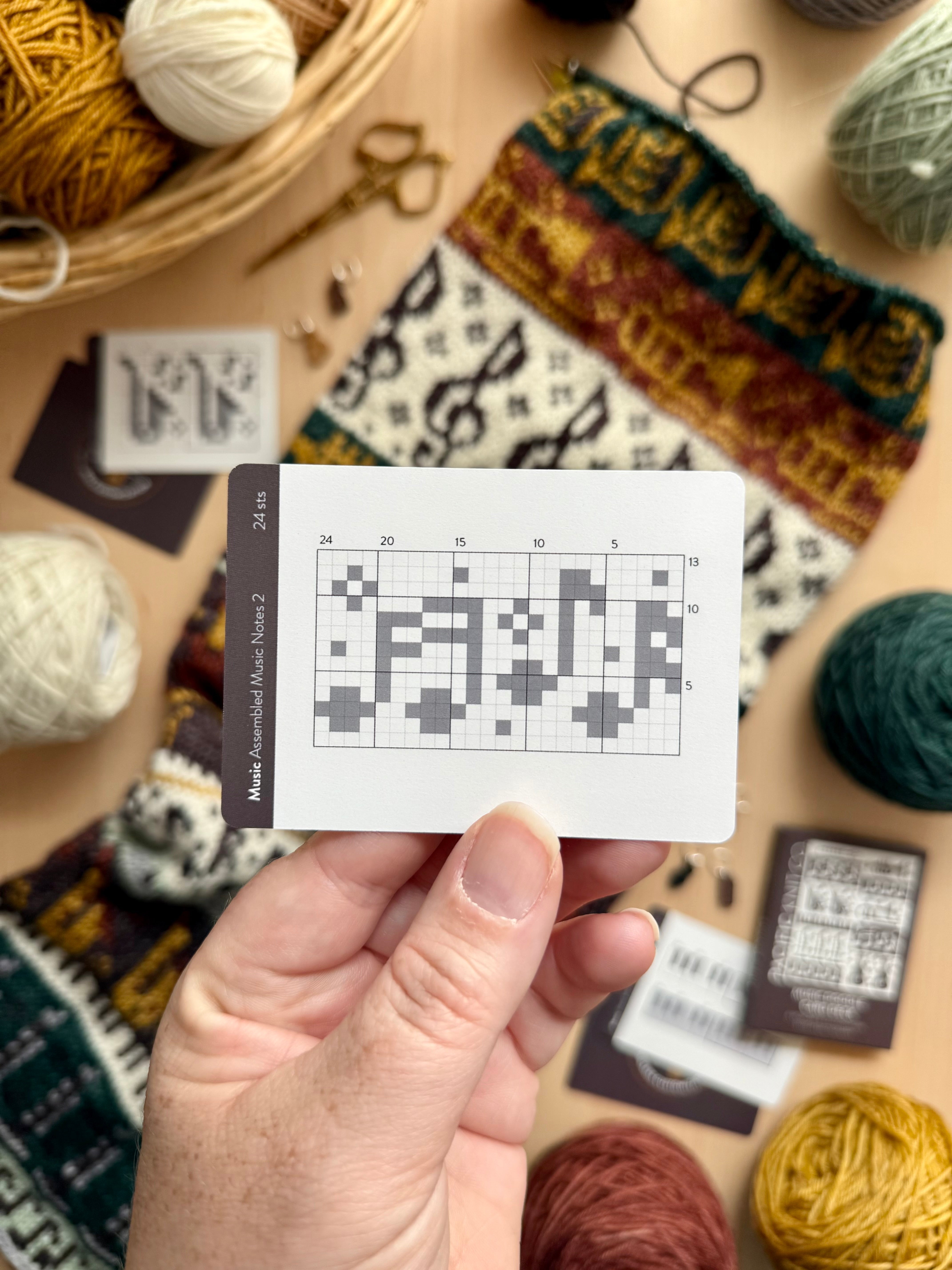Hand holding a Music Doodle music notes colorwork chart card