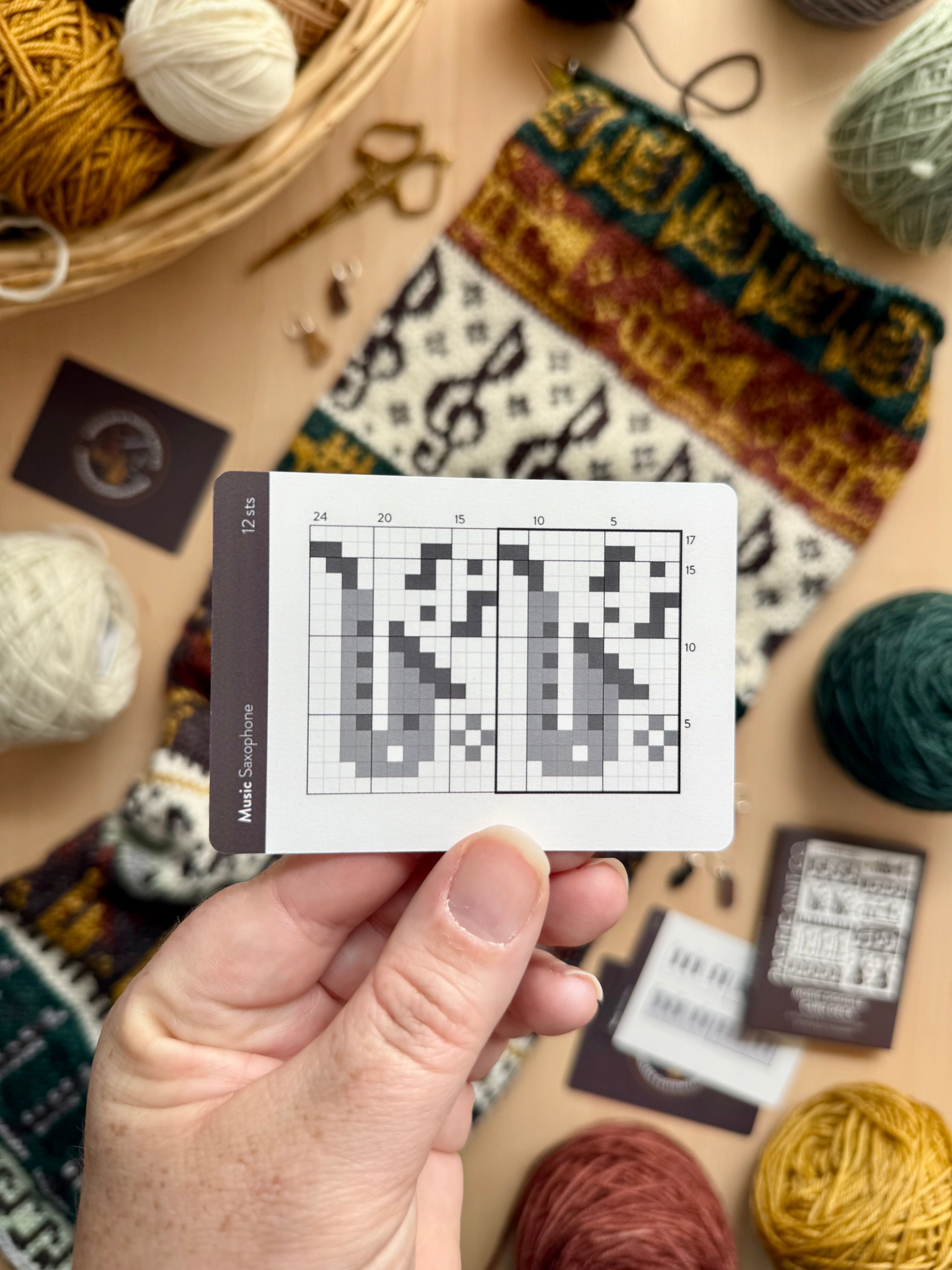 Hand holding a Music Doodle saxophone colorwork chart card