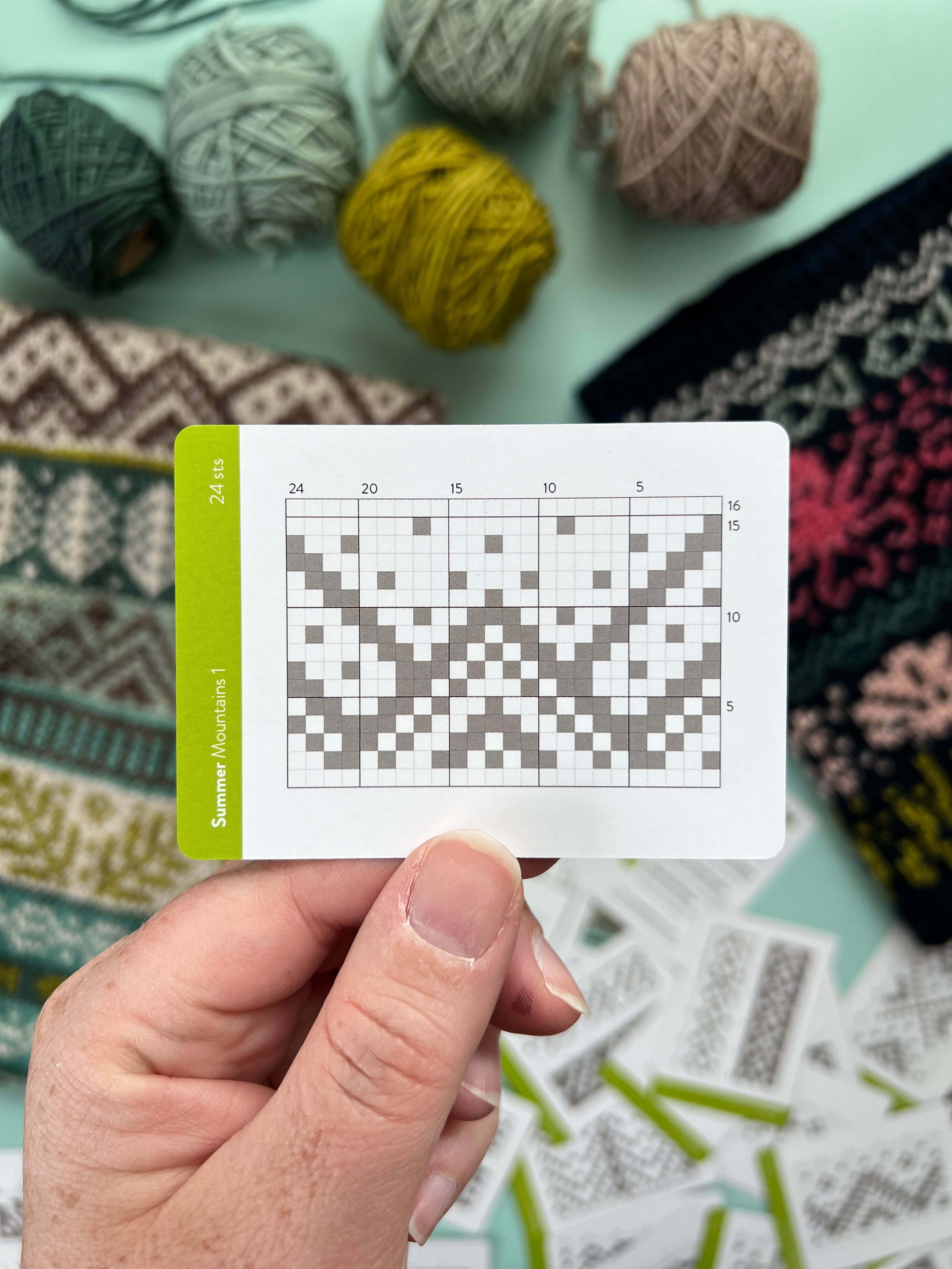 Hand holding a Summer Doodle mountains colorwork chart card