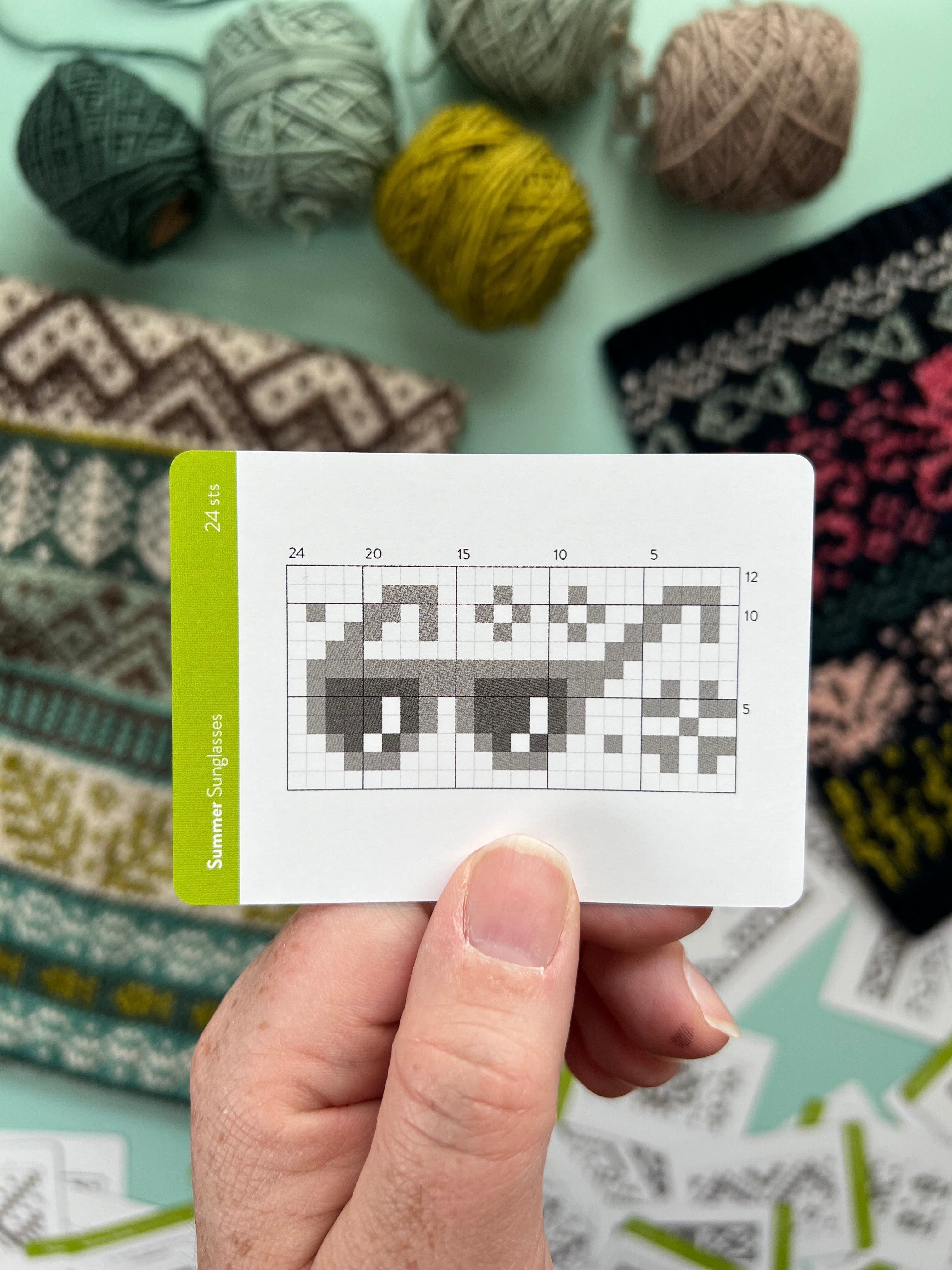 Hand holding a Summer Doodle sunglasses colorwork chart card