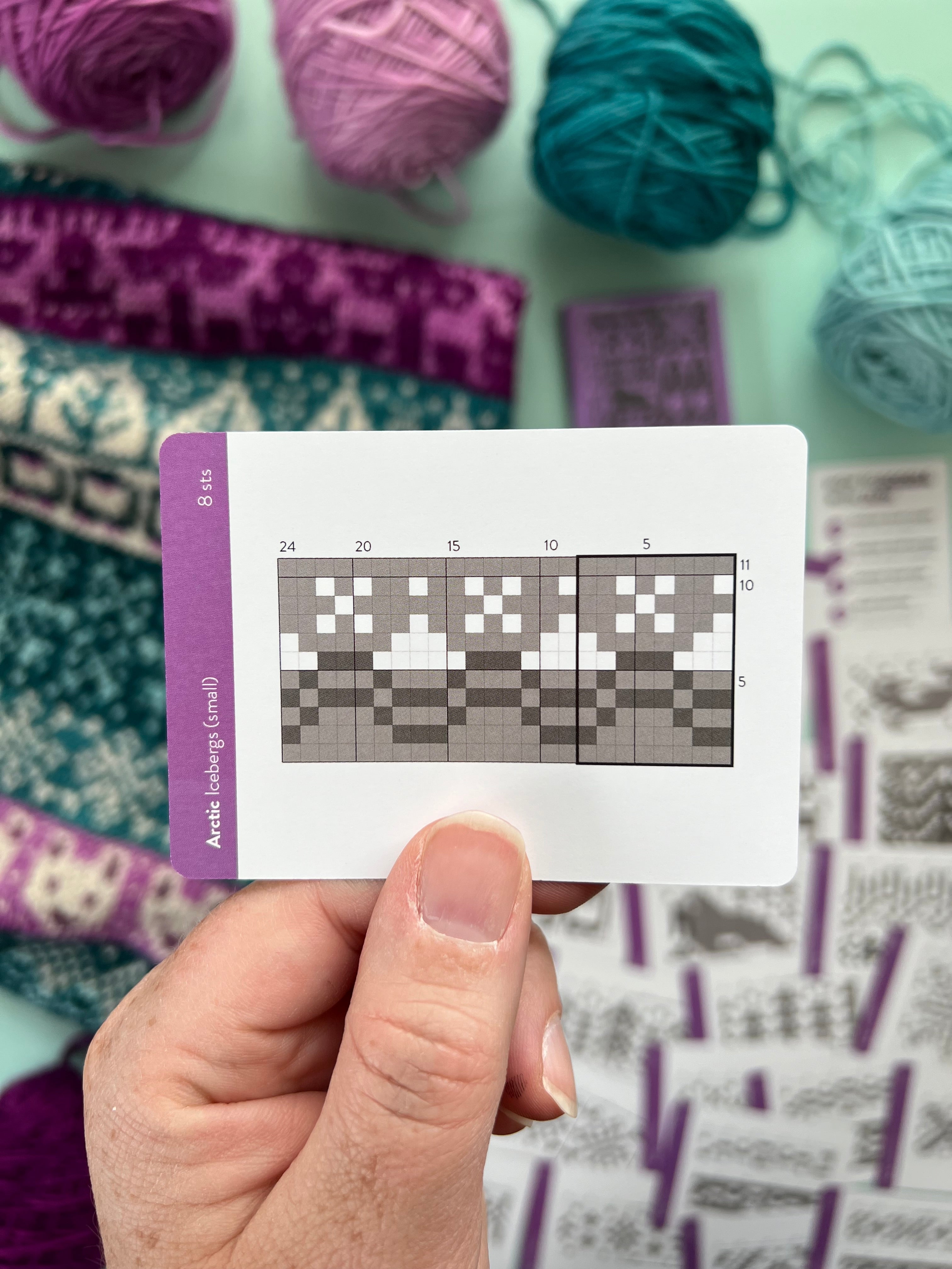 Hand holding an Arctic Doodle iceberg colorwork chart card