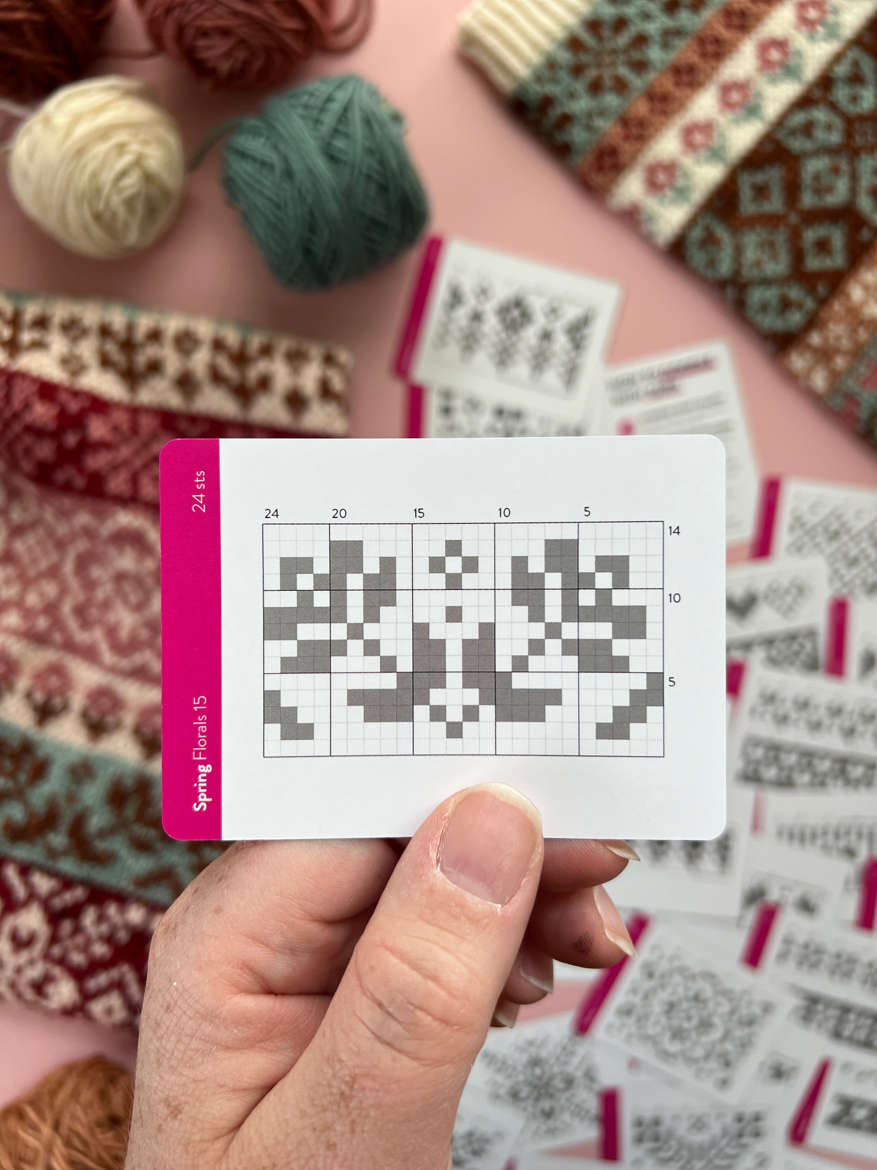 Hand holding a Spring Doodle tulip colorwork chart card