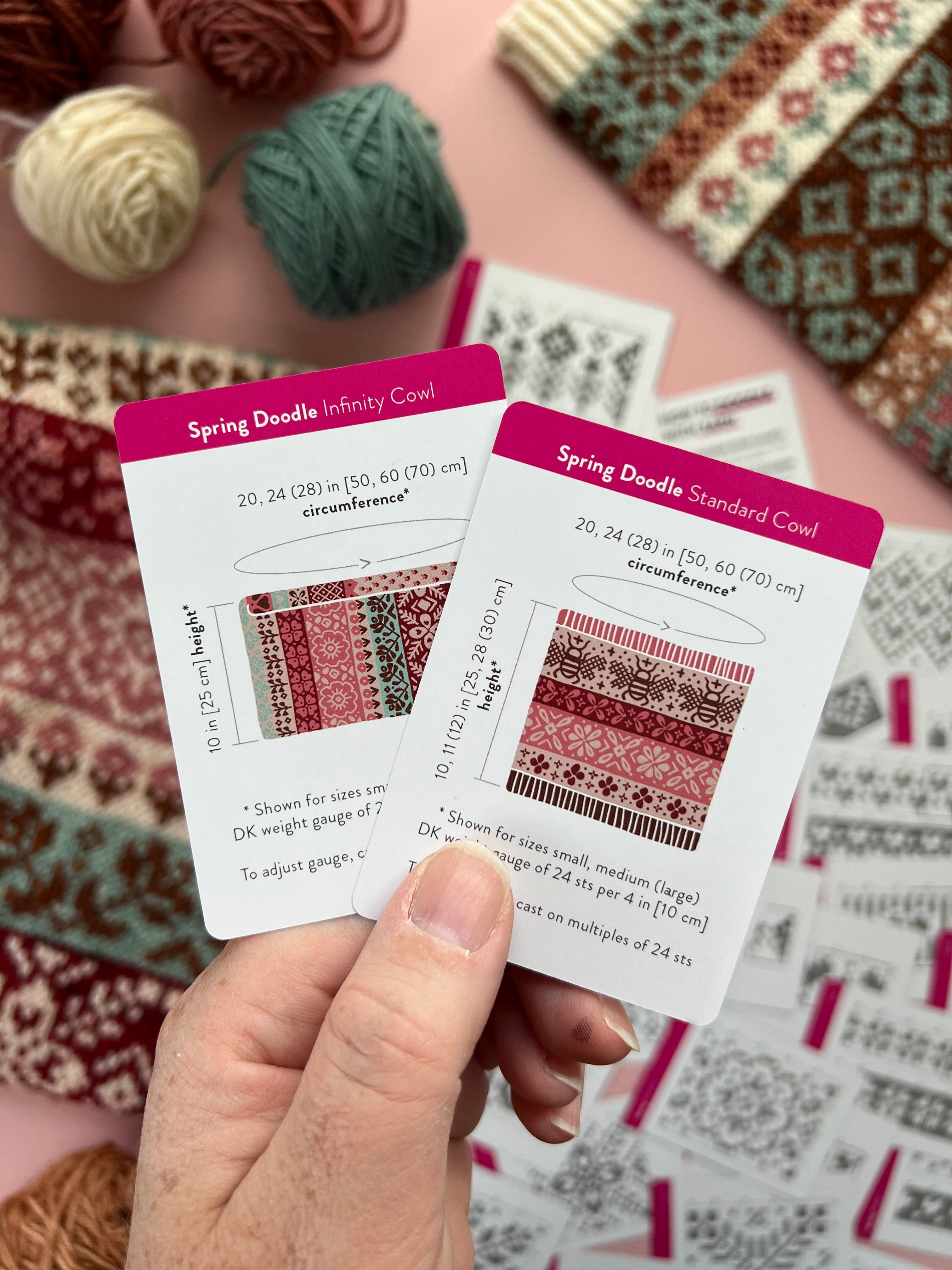 Hand holding the Spring Doodle Infinity Cowl and Standard Cowl schematic cards