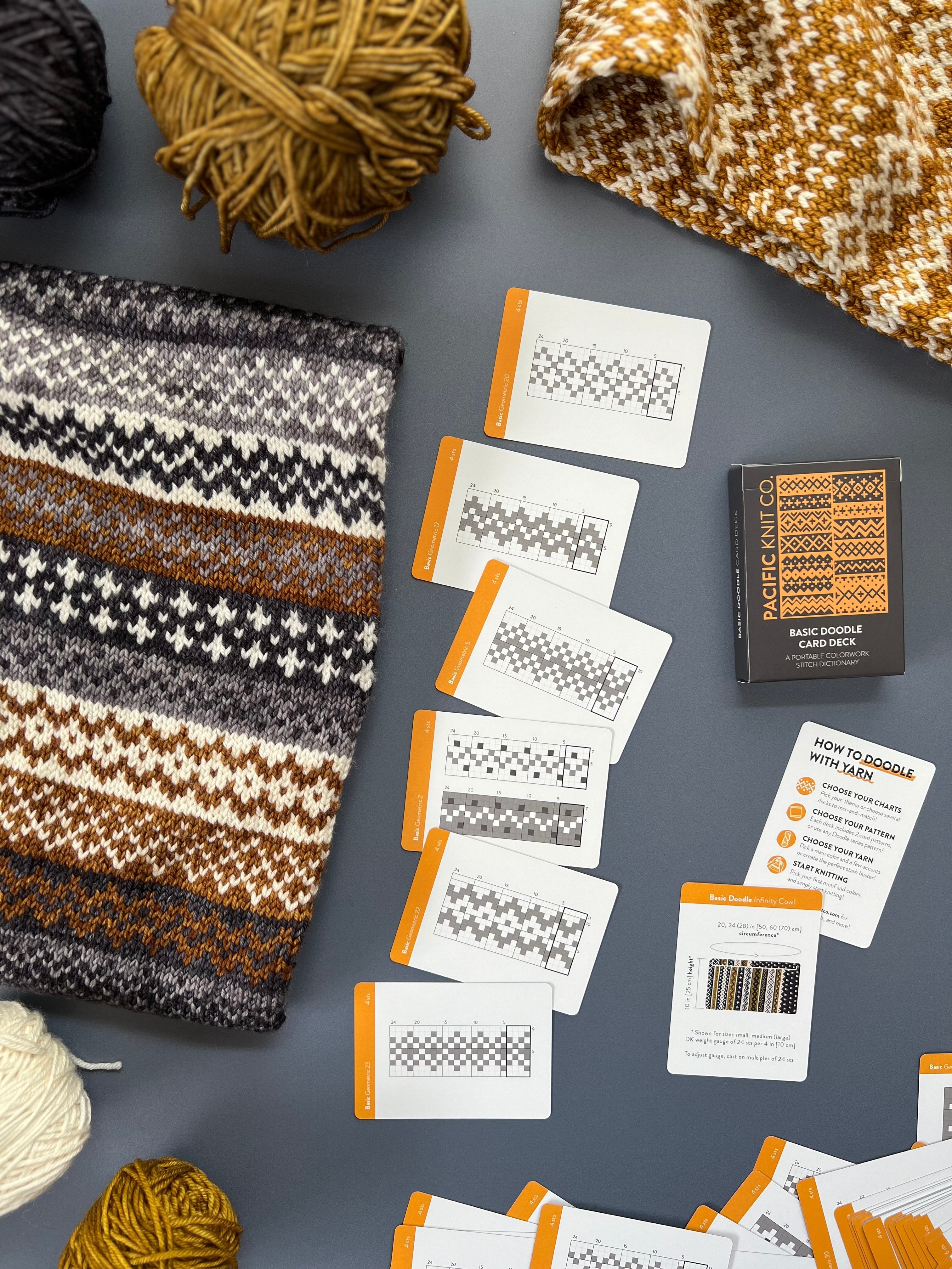 Basic Doodle deck and chart cards beside a striped gold and brown colorwork knit