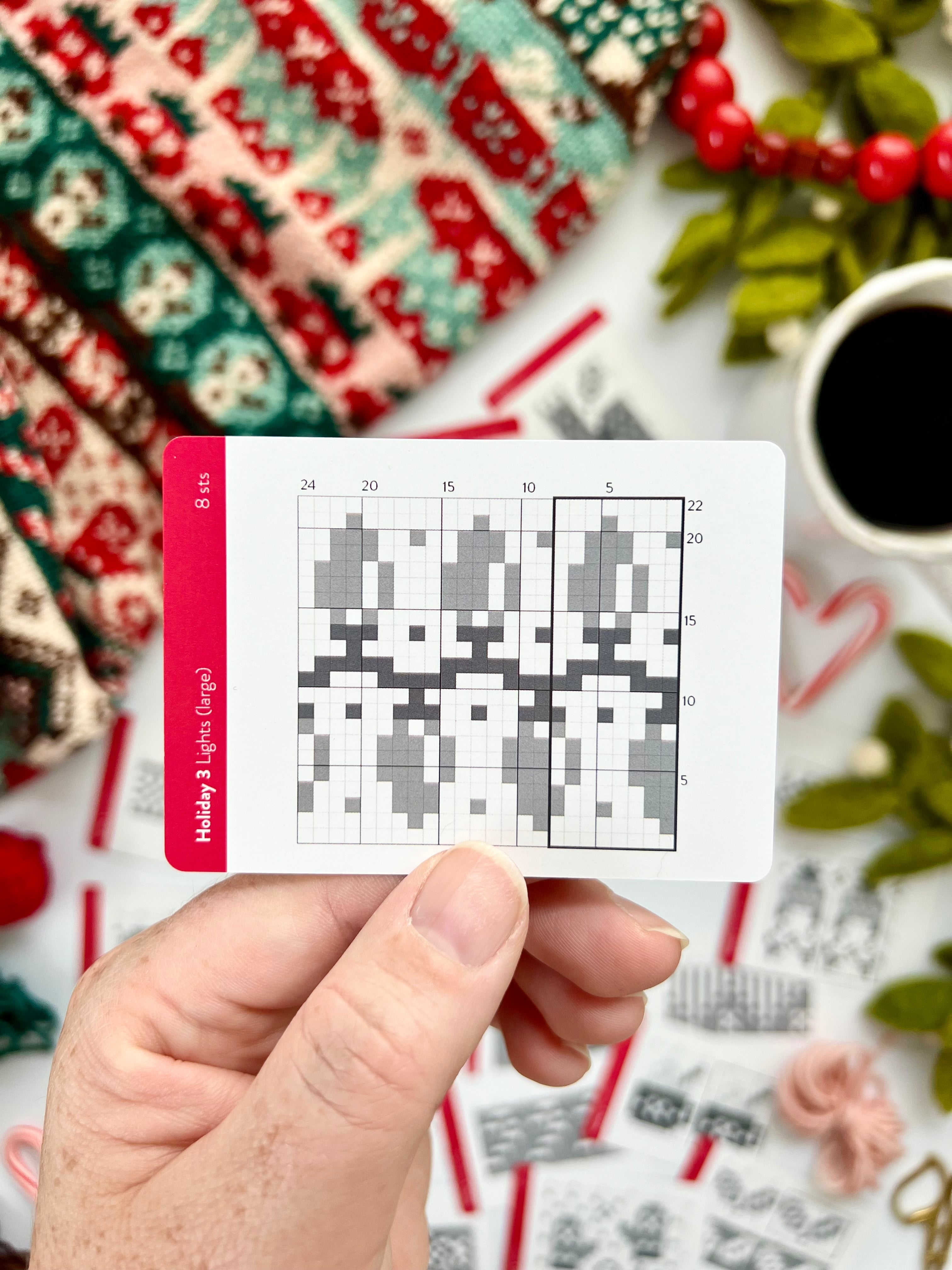 Hand holding a Holiday 3 Doodle holiday lights colorwork chart card