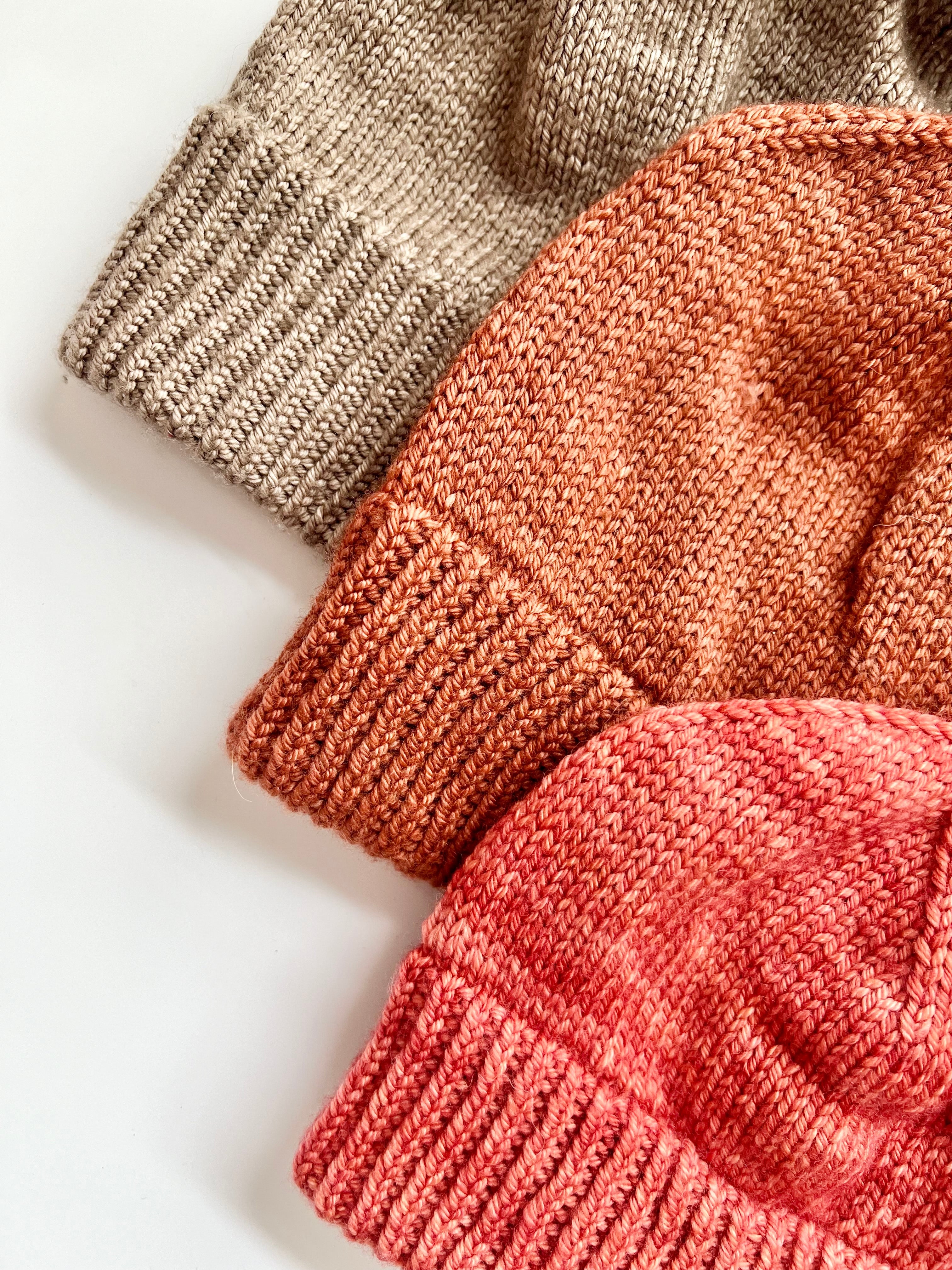 Close-up of the folded ribbed brims on three Base Doodle Beanie 2 hats