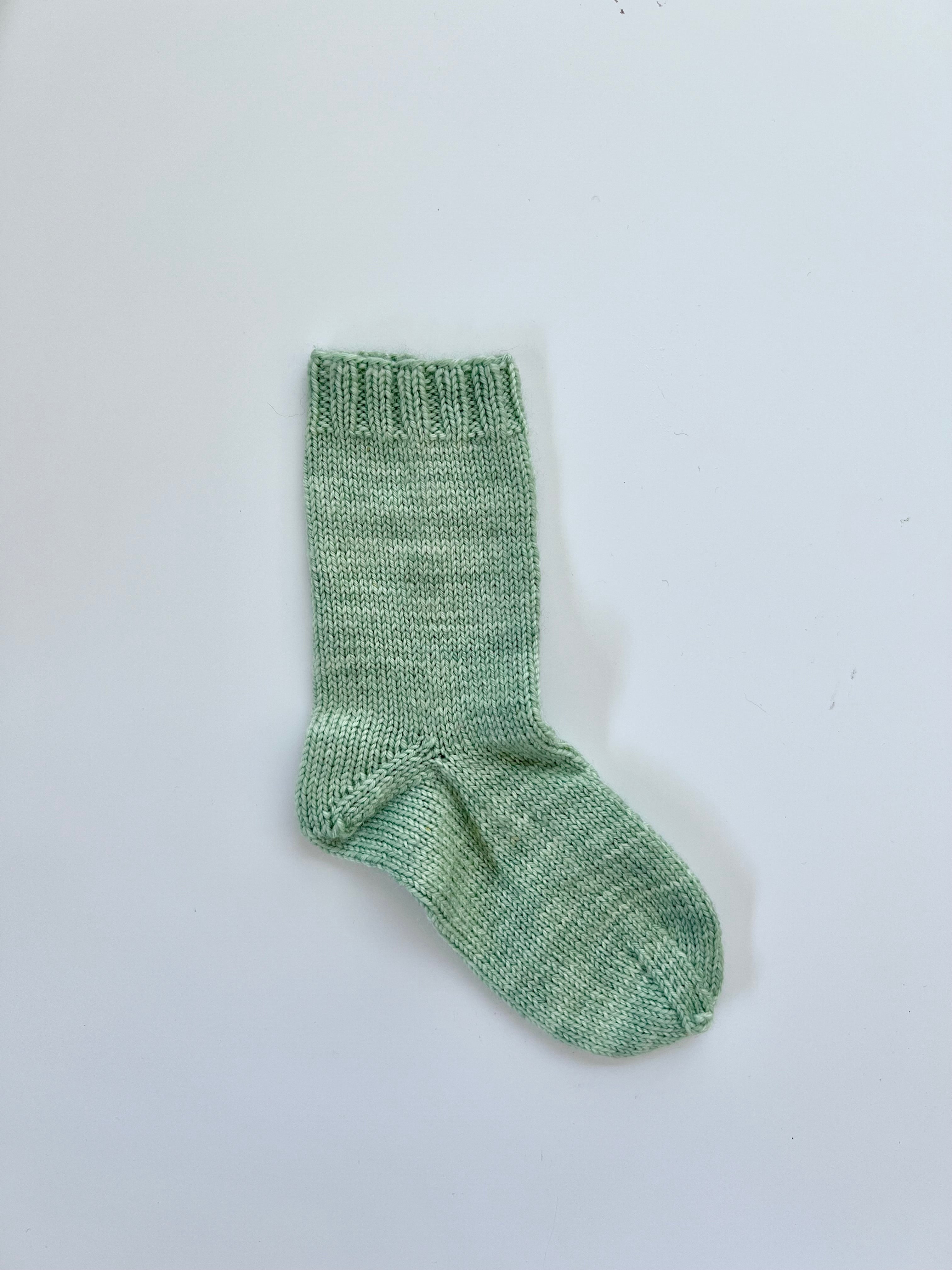 Small green Base Doodle Top-Down Sock in fingering weight yarn