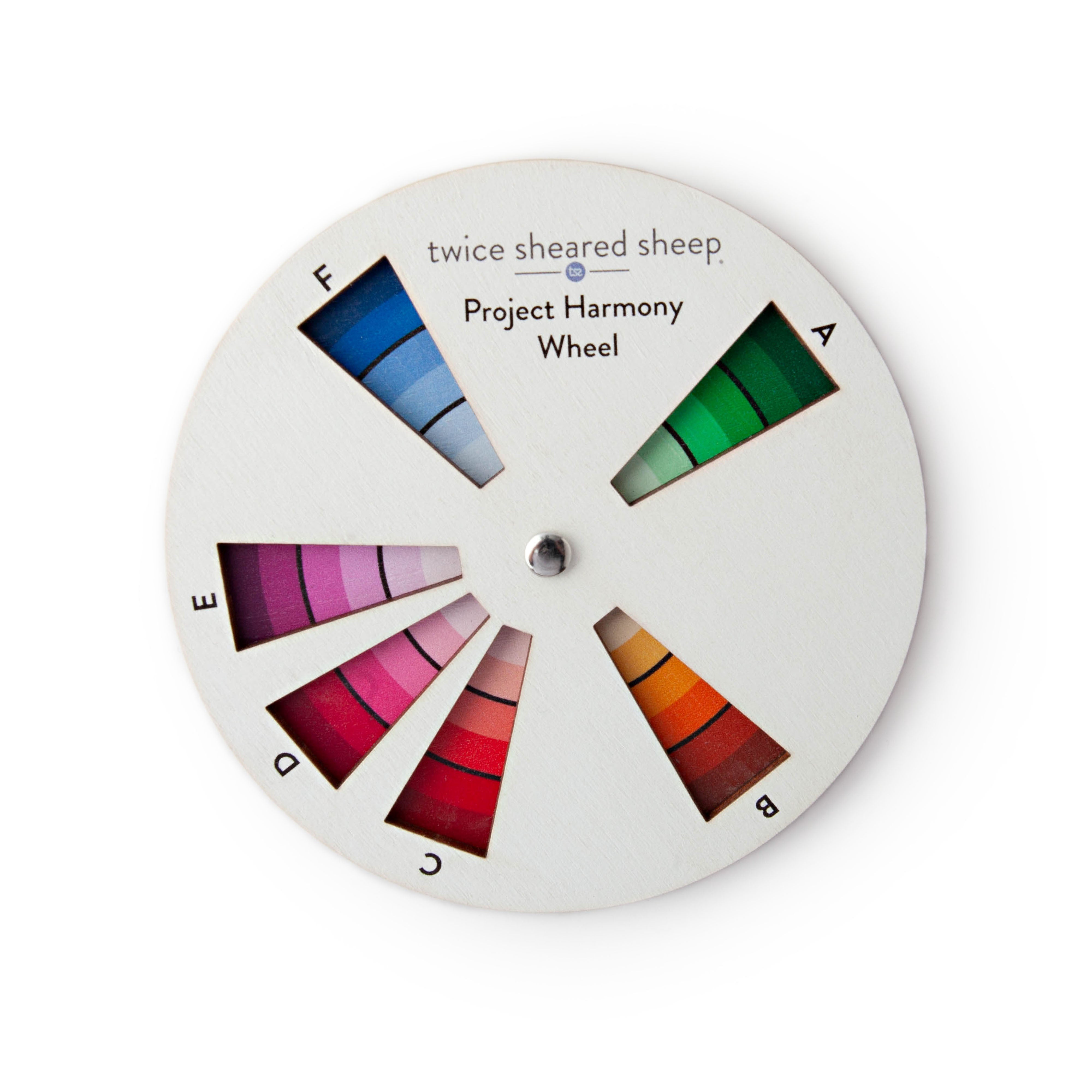 Project Harmony Wheel, a white wooden color wheel with six labeled windows showing graded green, orange, red, pink and blue yarn color swatches
