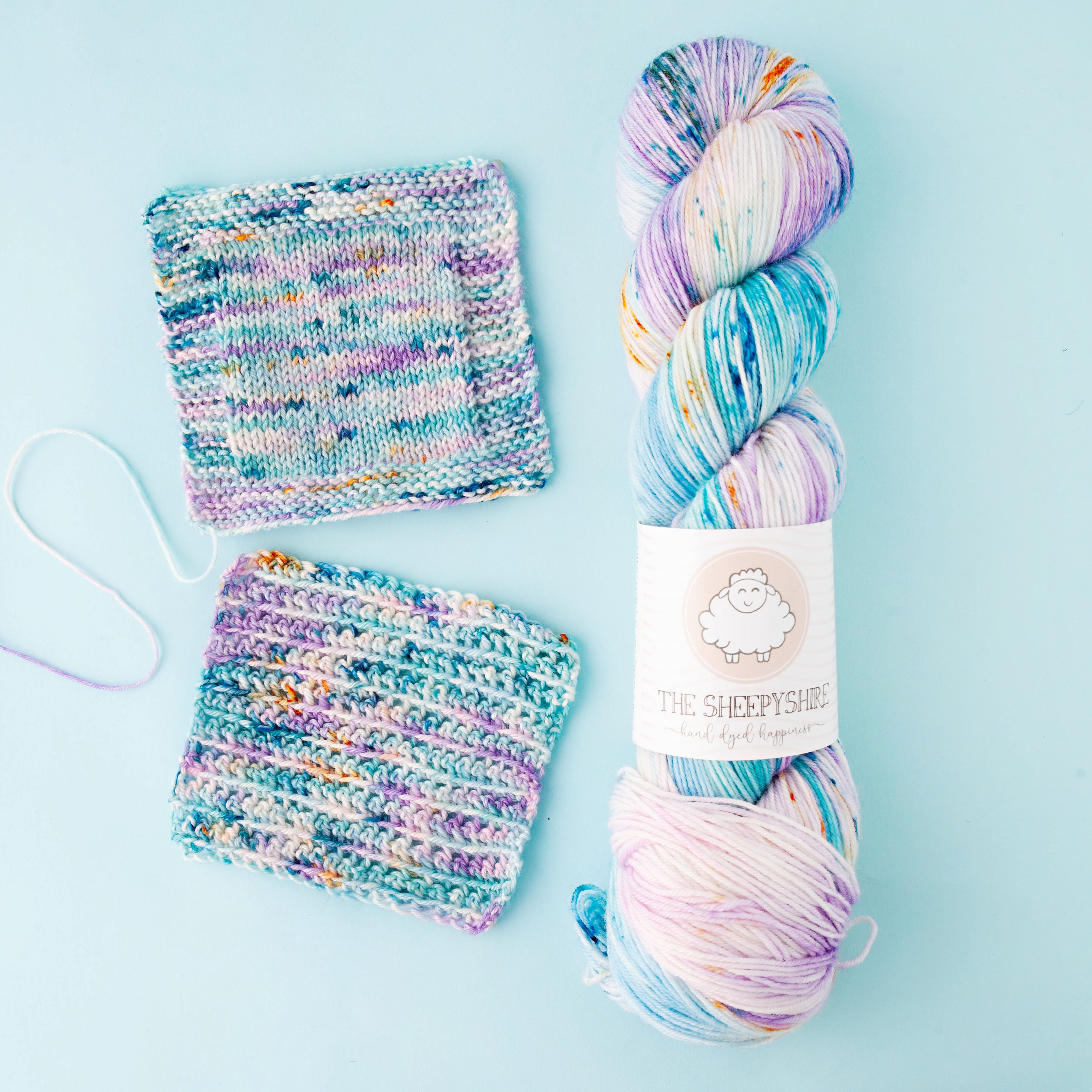 Multicolored yarn skein with a label on a light blue background