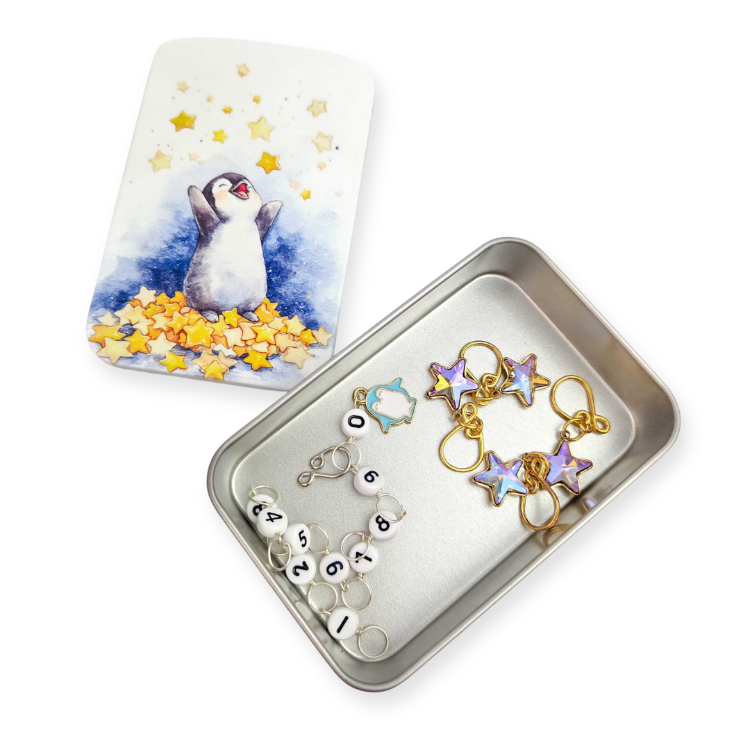 2026 LYS Exclusive Winter Gift Box open tin showing contents including floral and snowflake design items with yellow star confetti