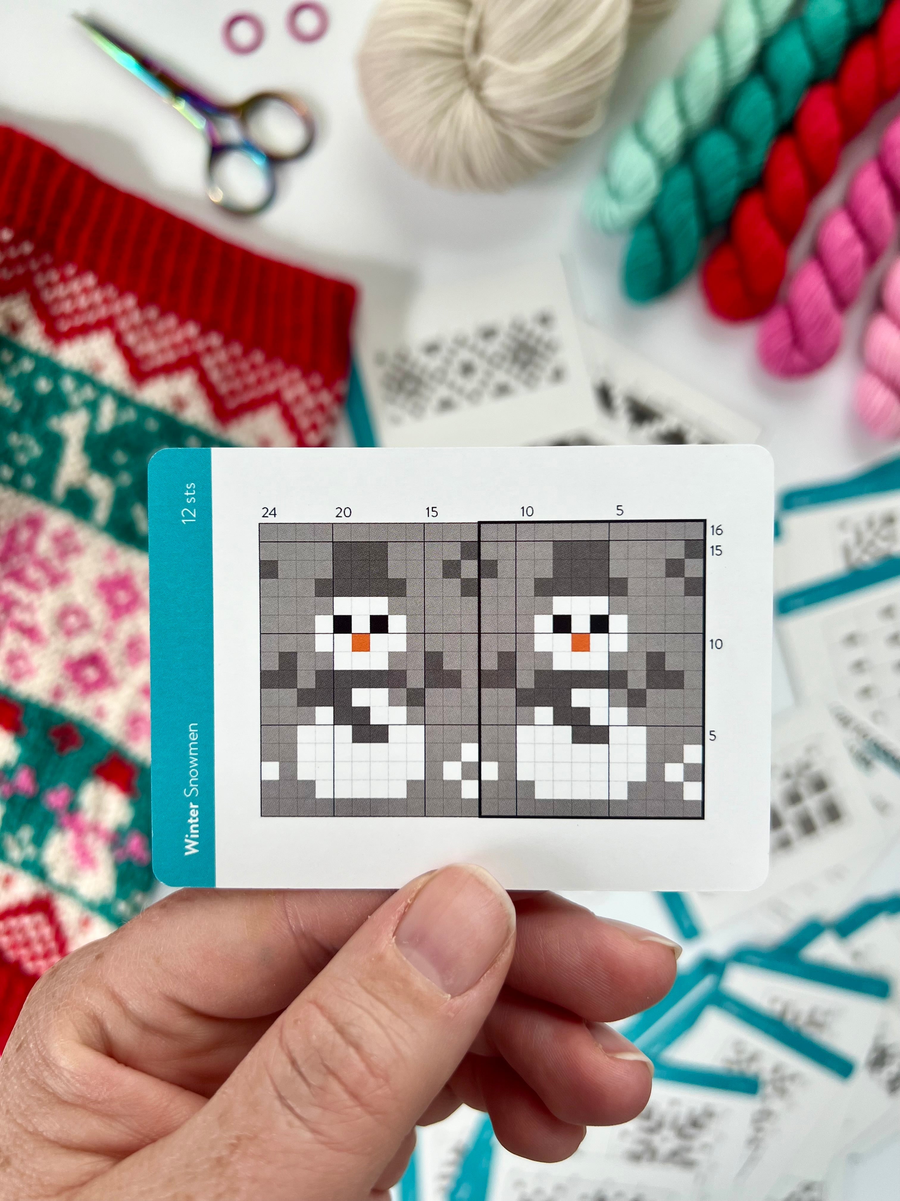 Hand holding a Winter Doodle snowman colorwork chart card