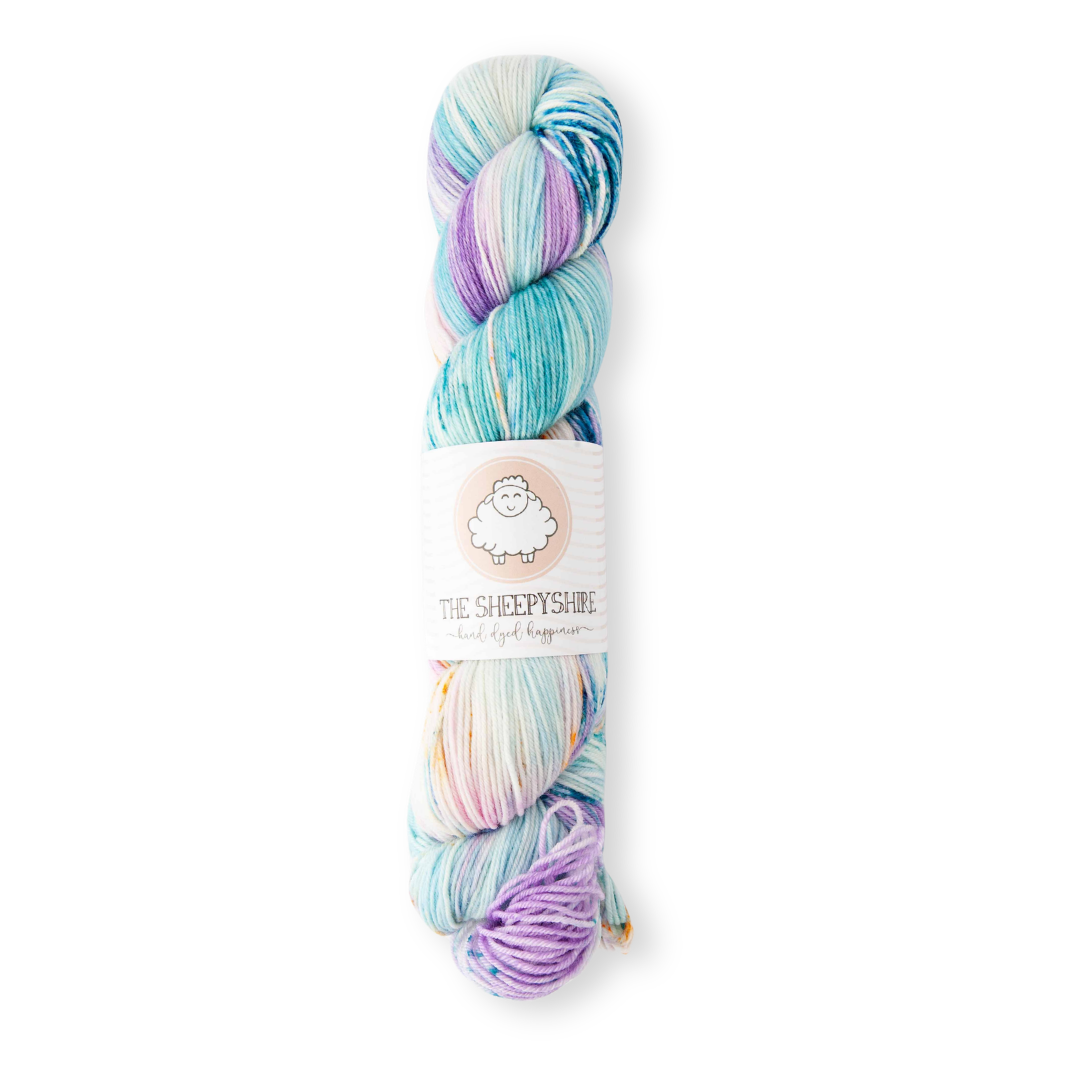 Multicolored skein of yarn with a label on a white background