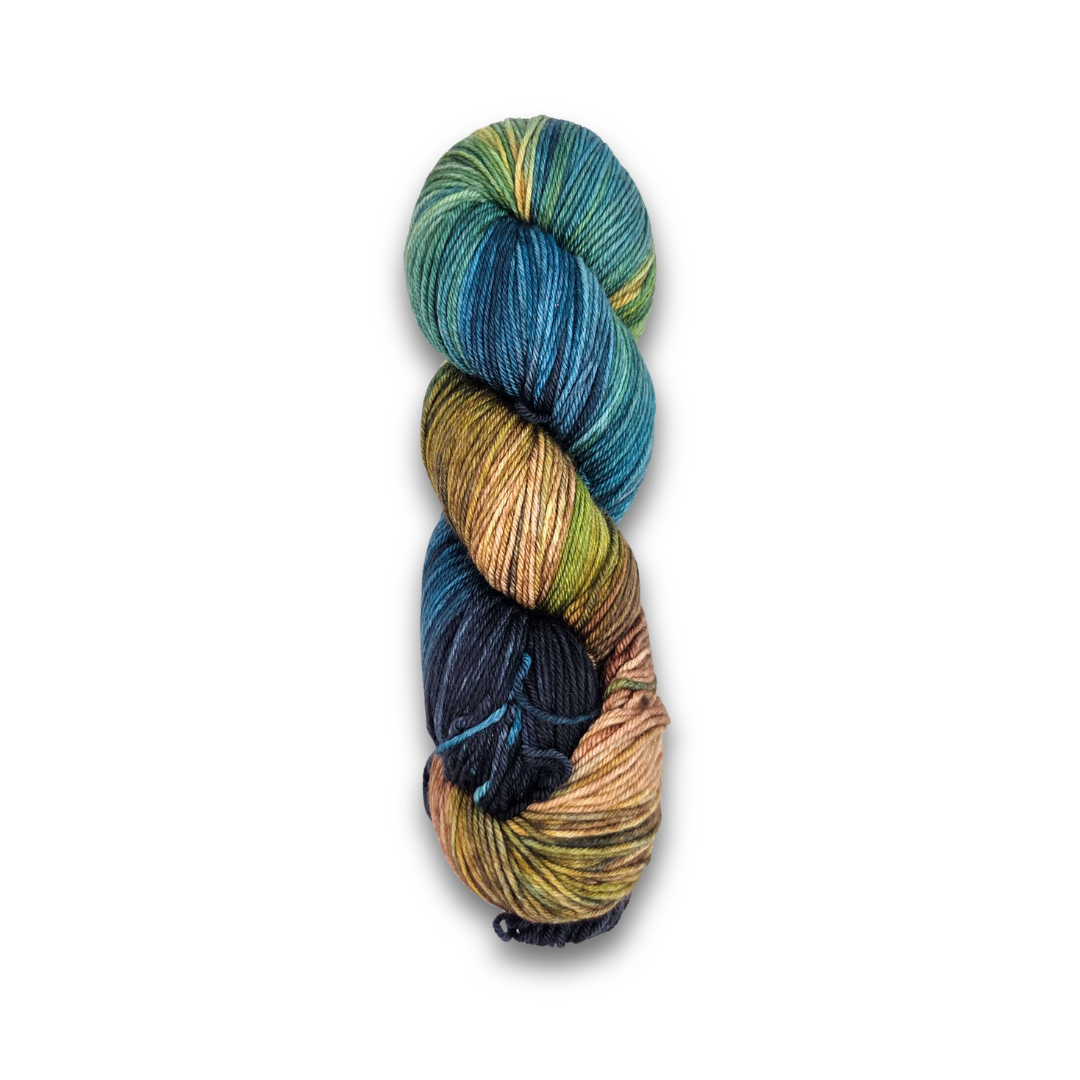 Yarnaceous Fibers Smuggler's Bay sock yarn skein shown twisted, dark teal, navy, olive and sandy tan